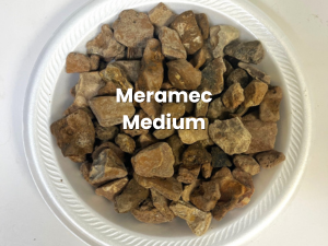 White plate of small brown rock pieces labeled “Meramec Medium”