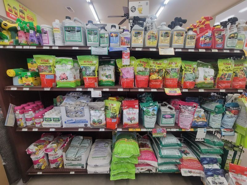 Pet store shelf stocked with colorful pet food pouches and bags in neat rows