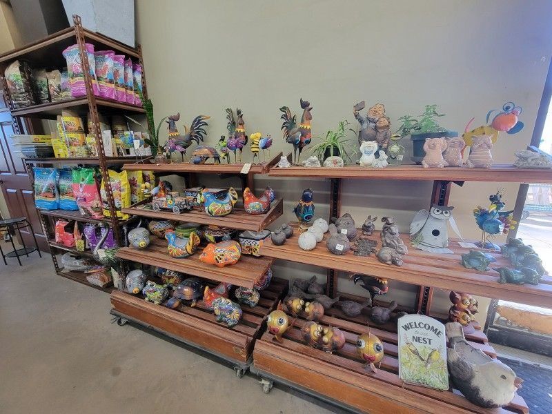 Stuffed animal and plush toy display on wooden shelves in a store aisle