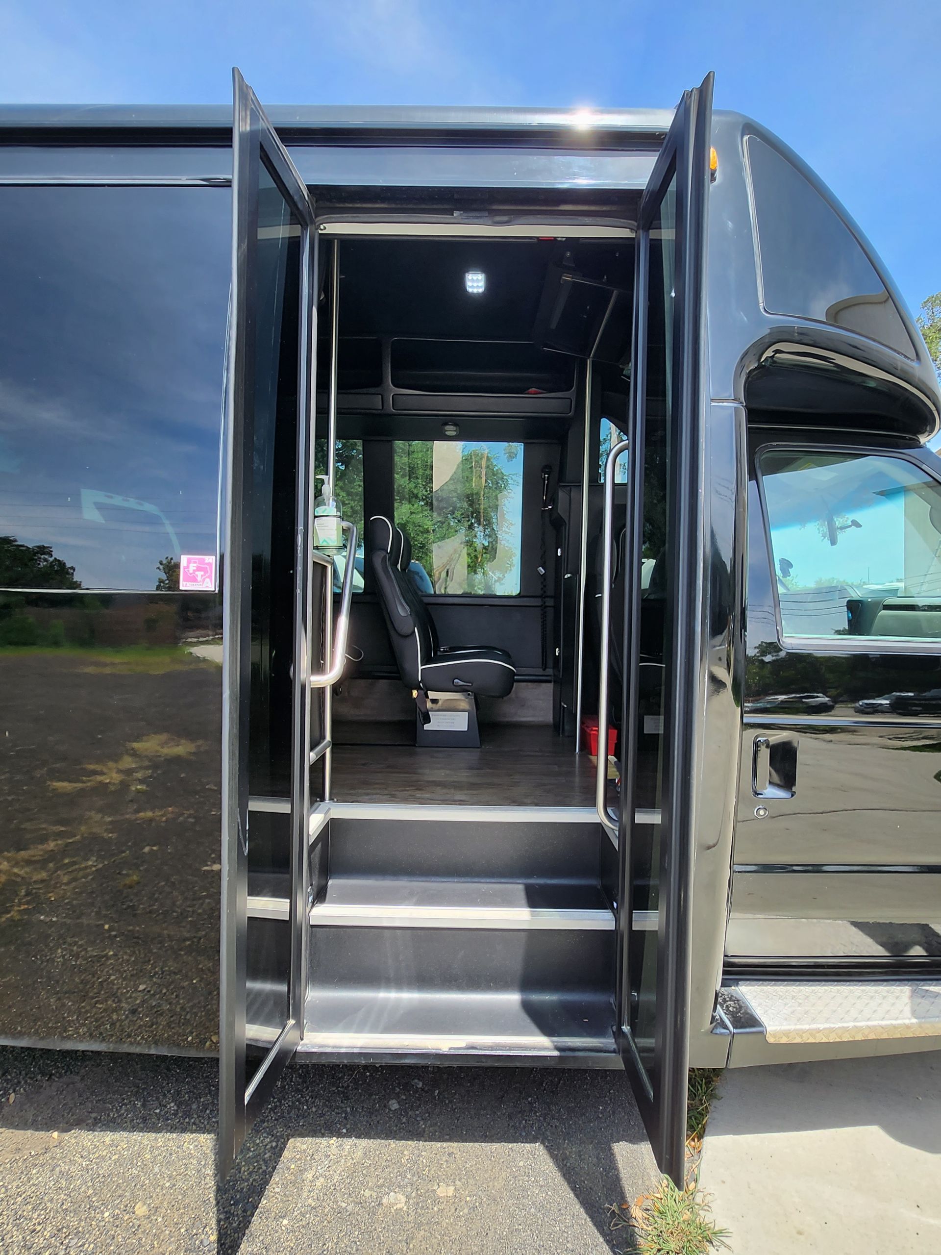 Black bus doorway with open doors