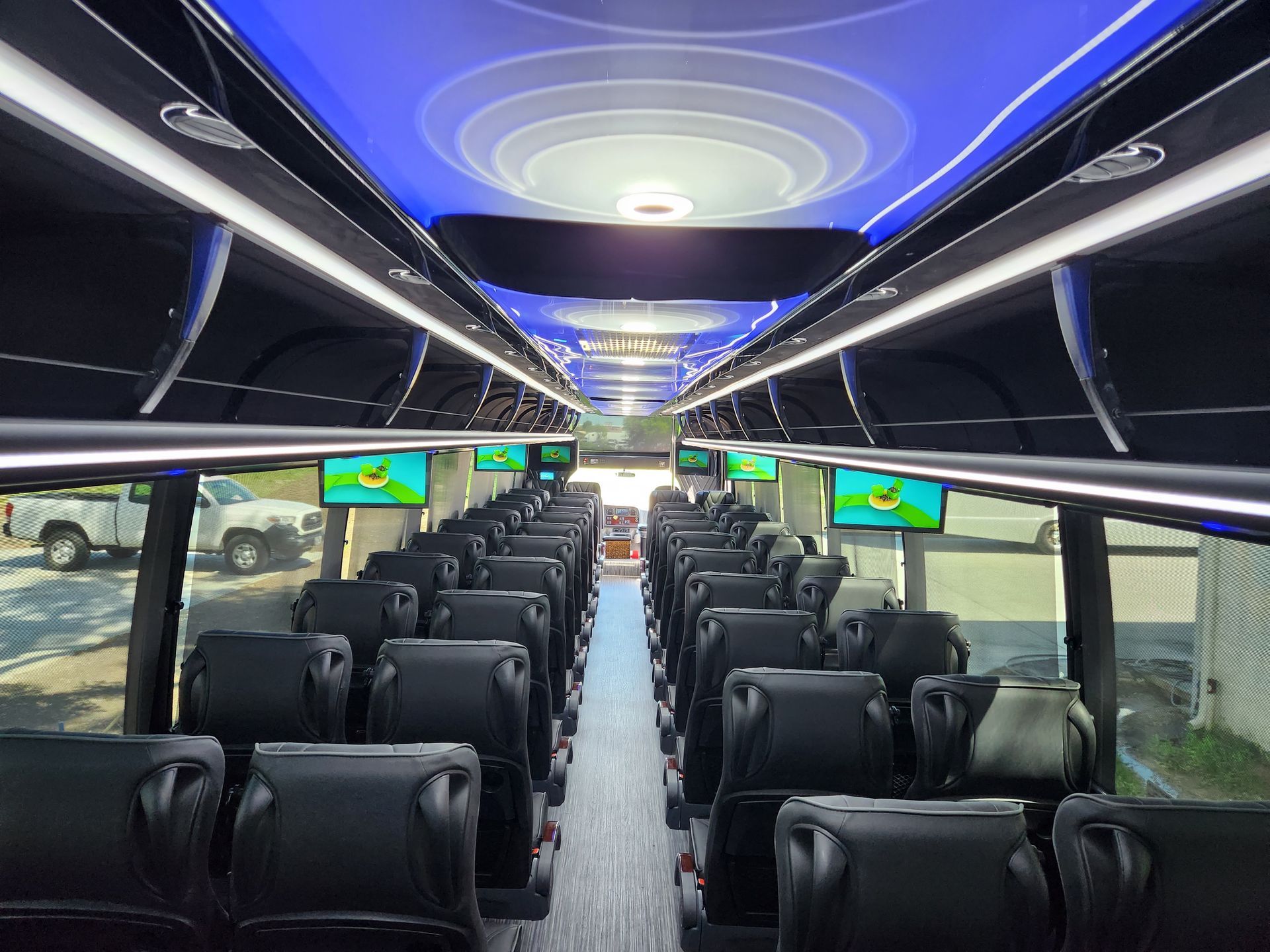 Interior of a  bus with rows of black seats