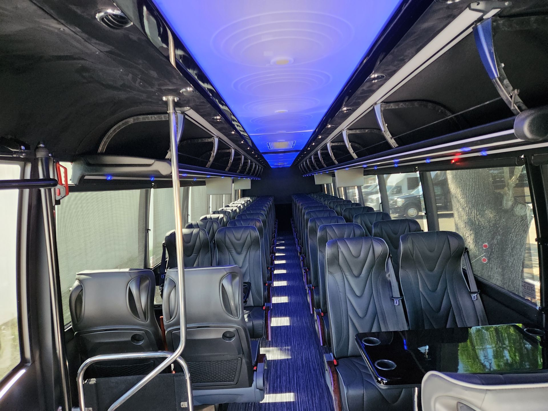 Interior view of a bus with rows of black seats