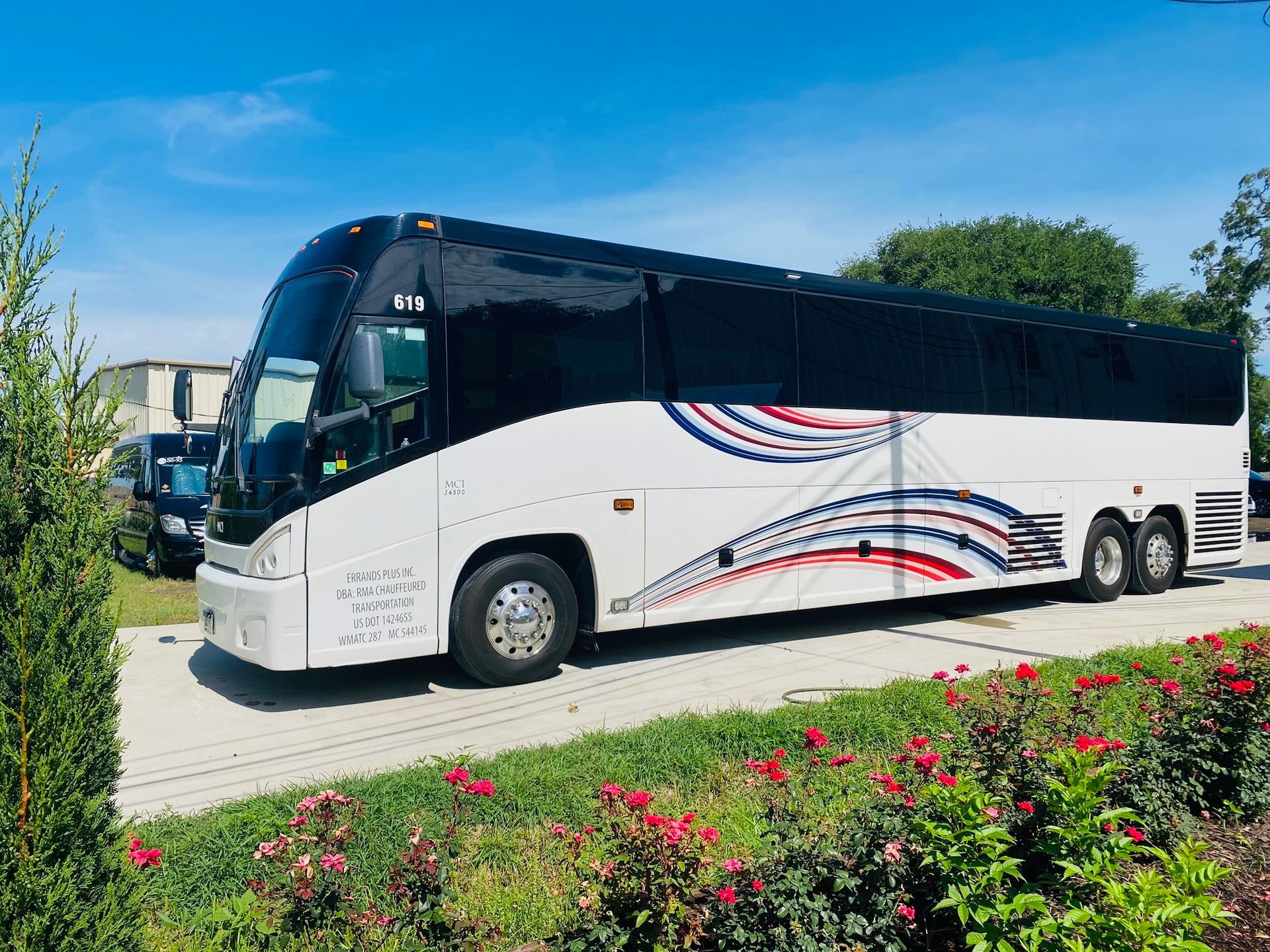 A white coach bus with black windows