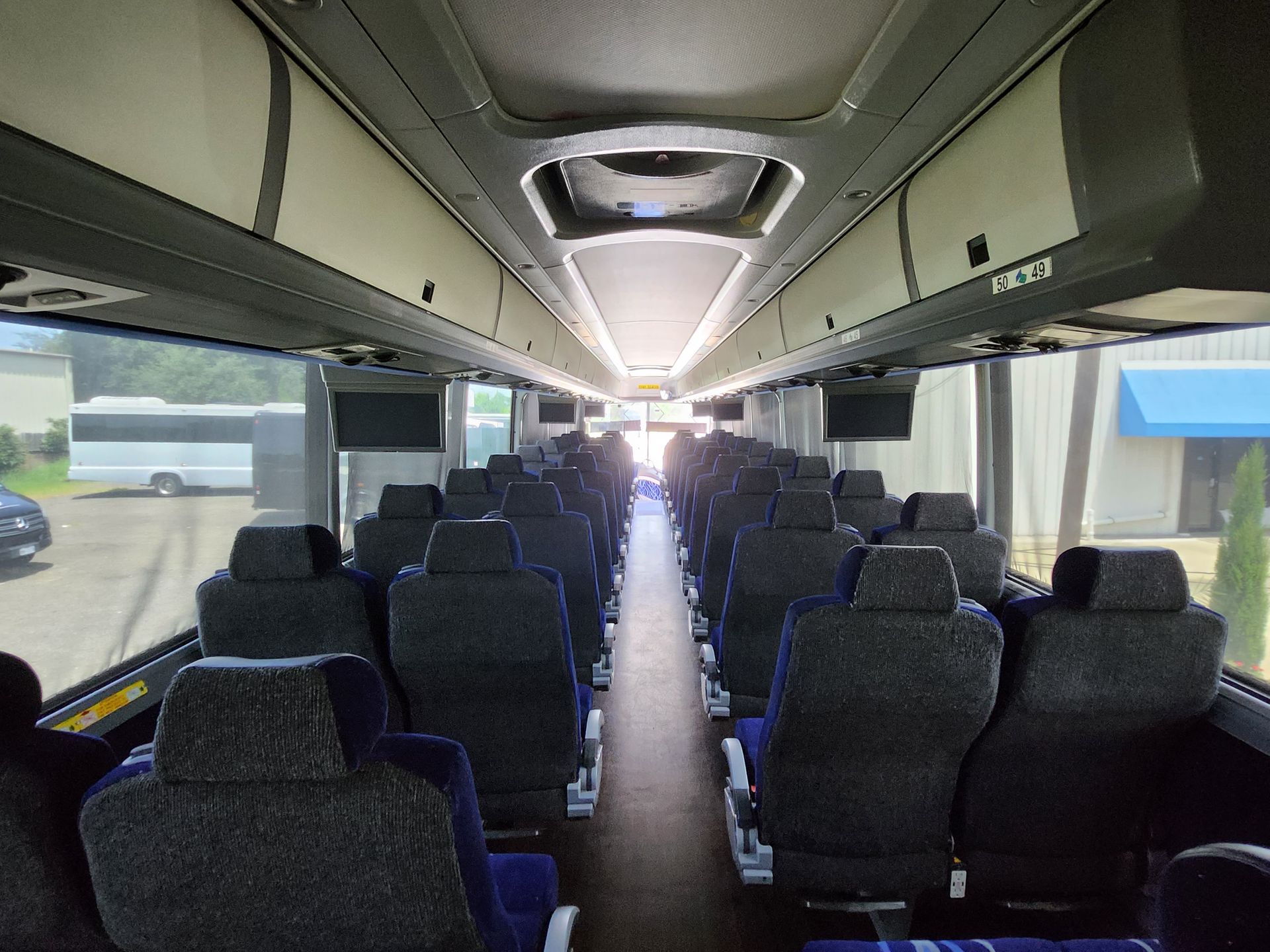 Interior view of an empty bus with rows of blue and black seats