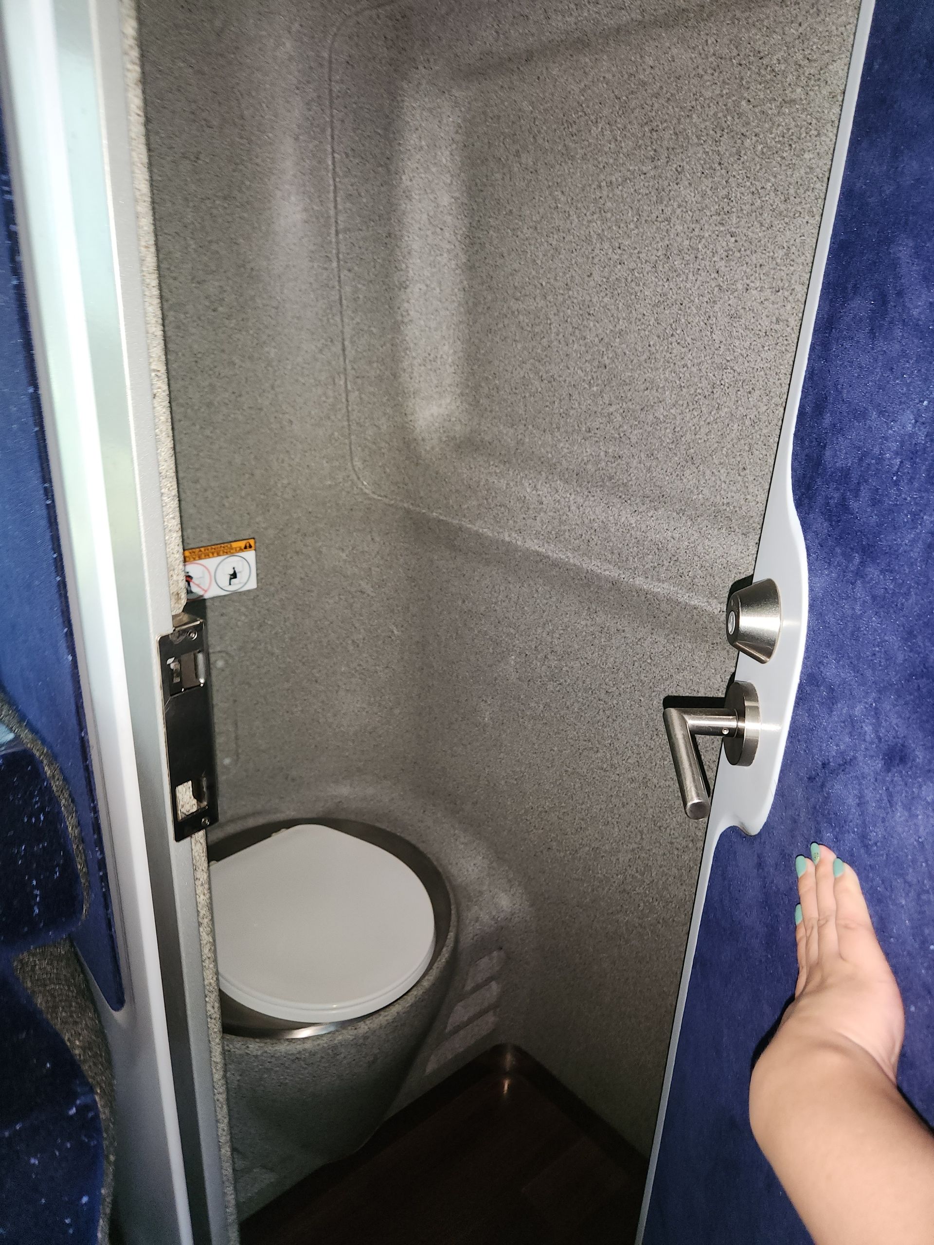Small, enclosed bathroom with a toilet