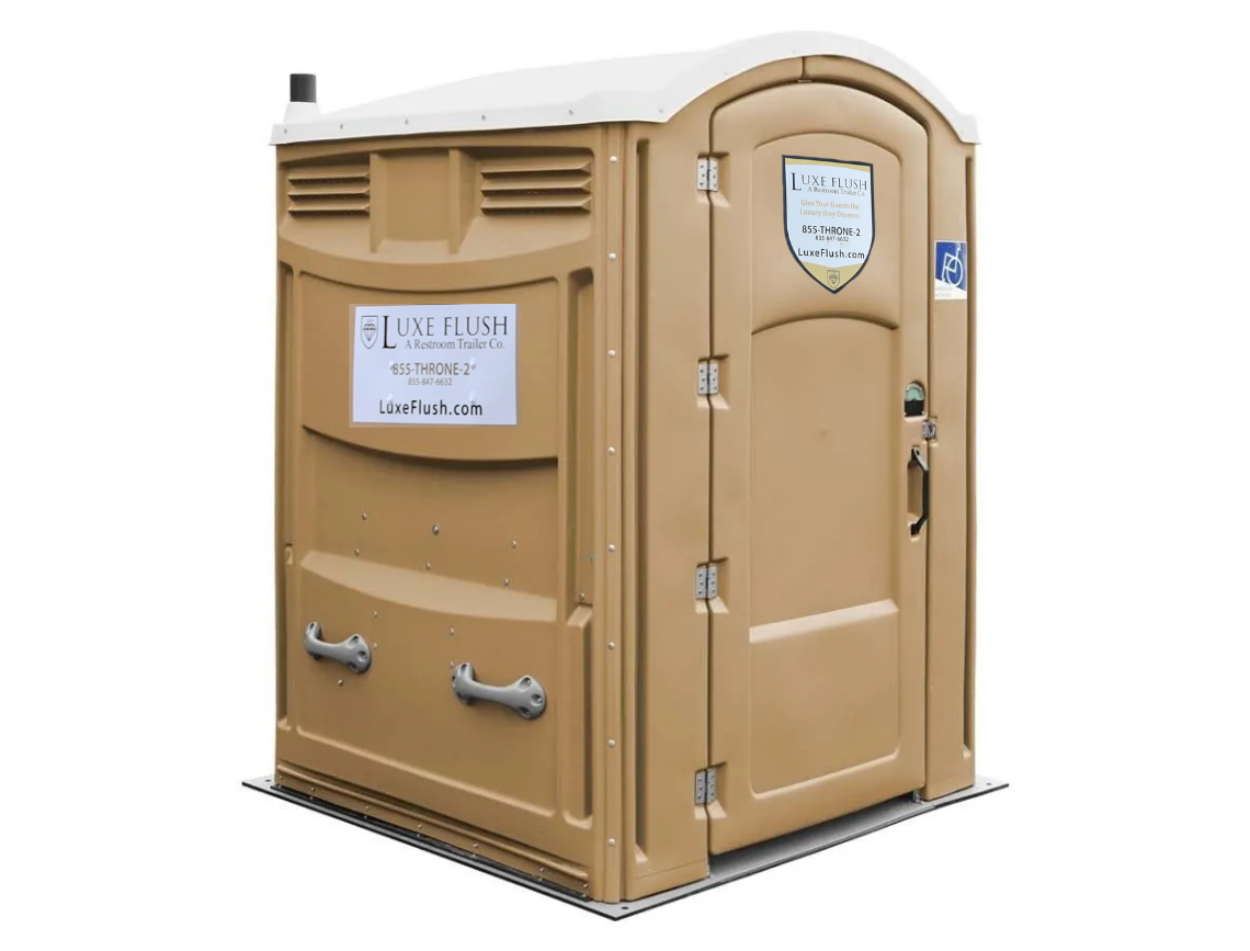 Tan portable toilet, with white roof, and blue handicap accessible sign.