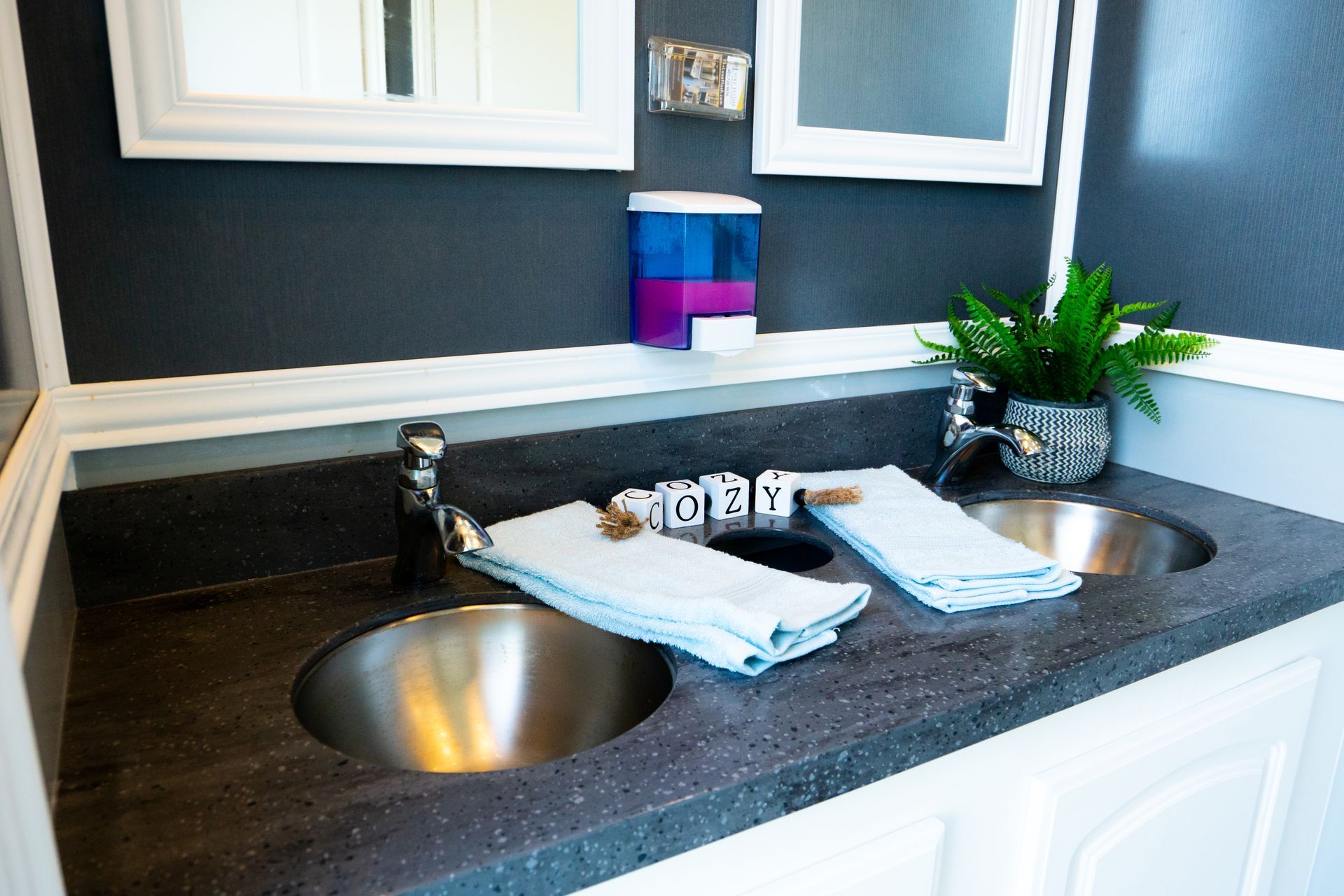 A bathroom with two sinks and two mirrors