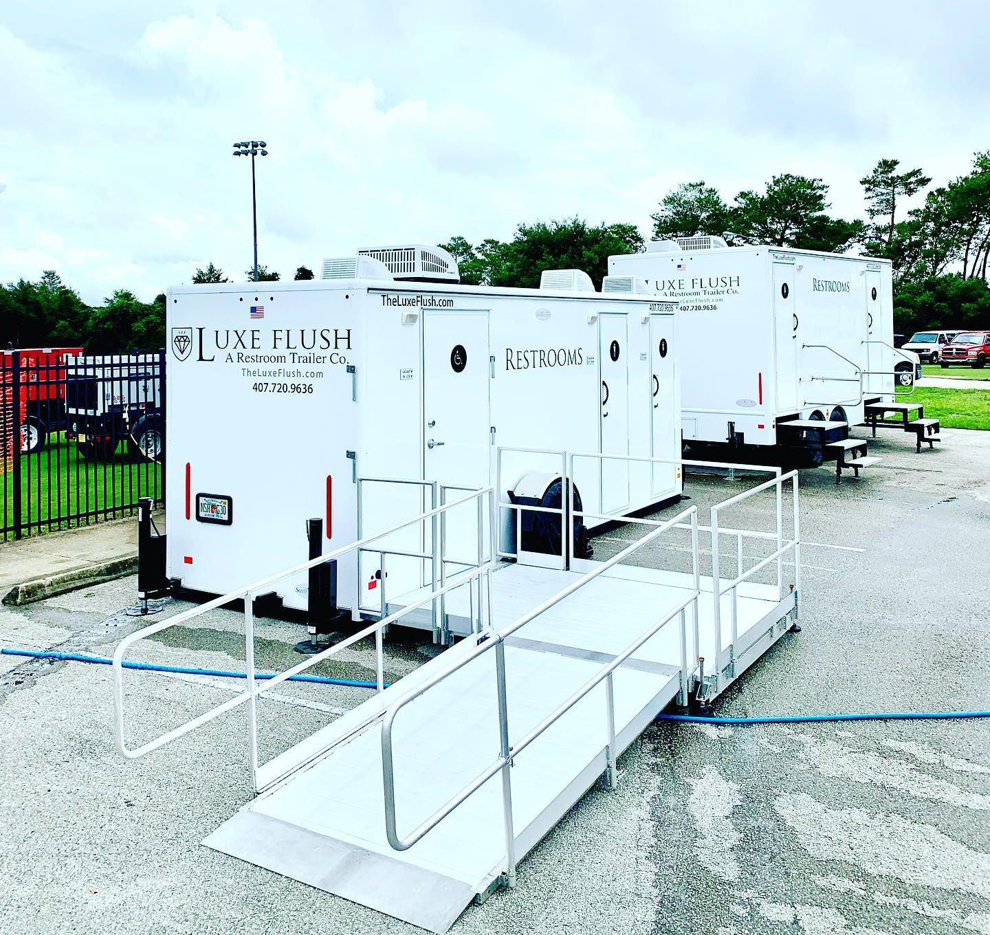 A row of white trailers with a ramp leading to them