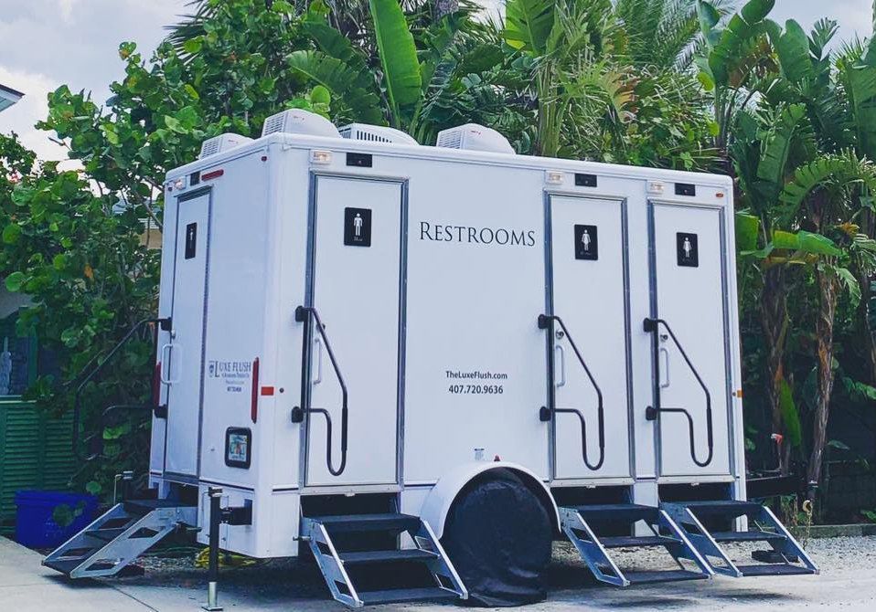 A white trailer with the word restrooms on it