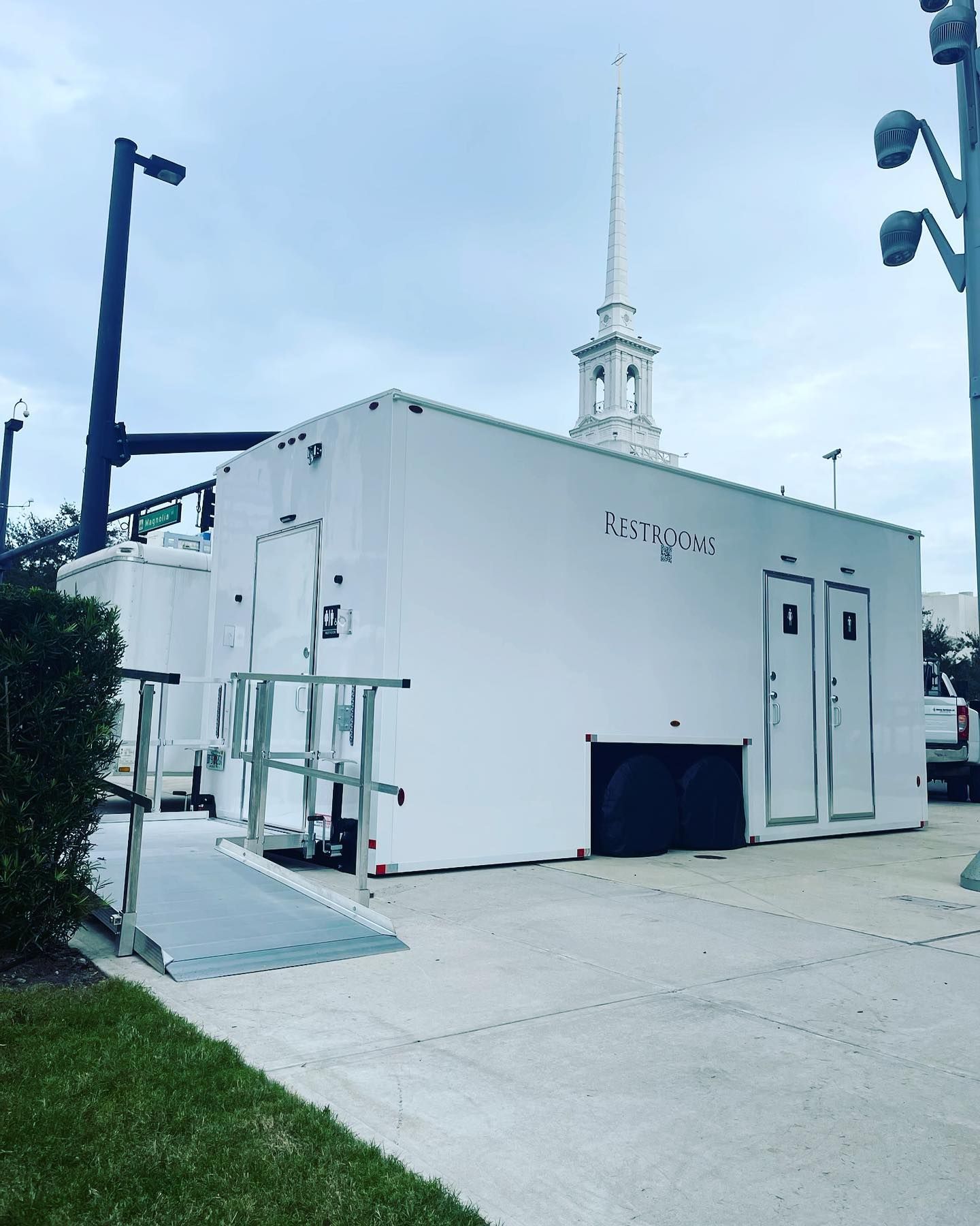 A large white building with a steeple in the background