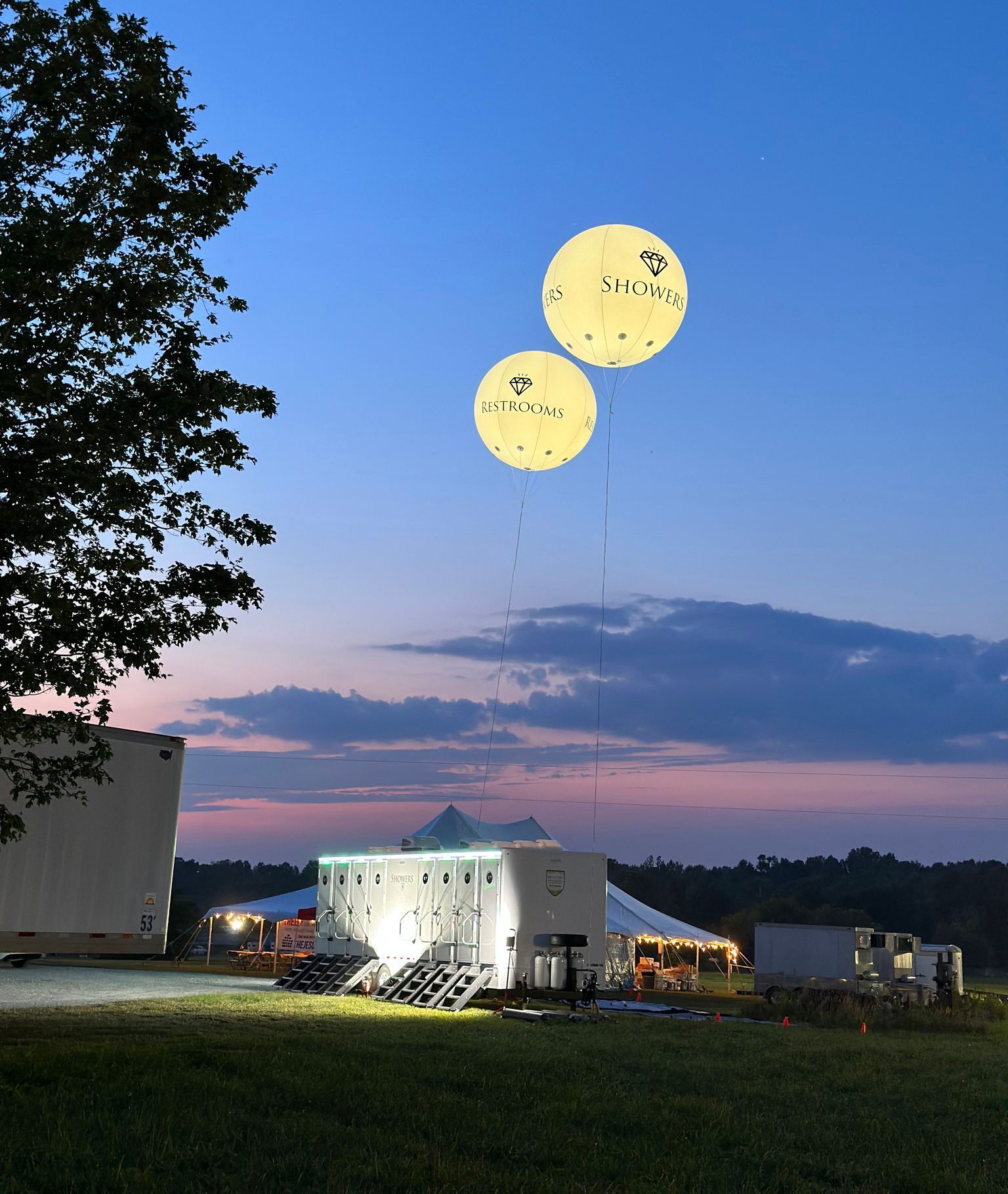 Two balloons are flying in the sky above a building