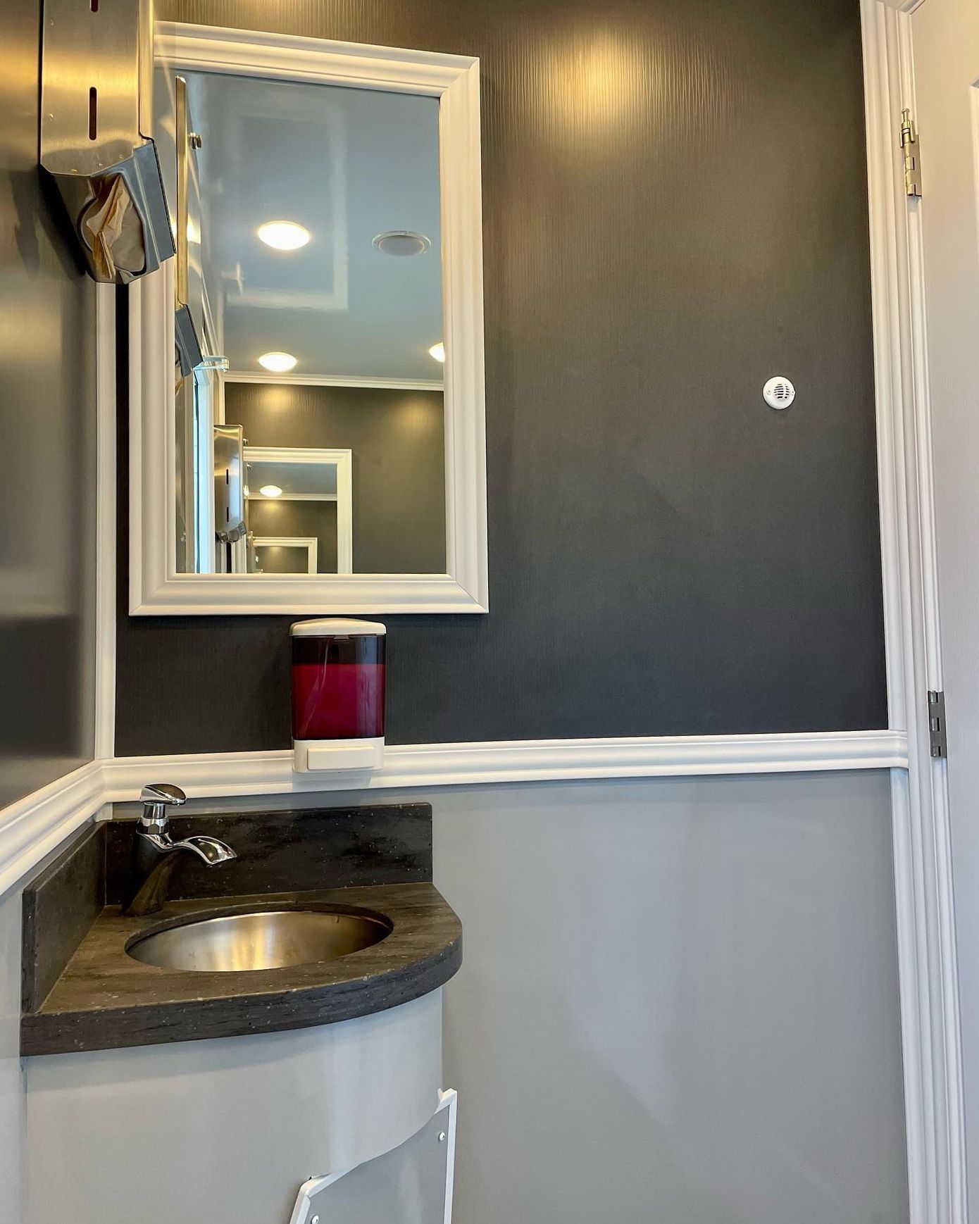 A bathroom with a sink and a mirror on the wall