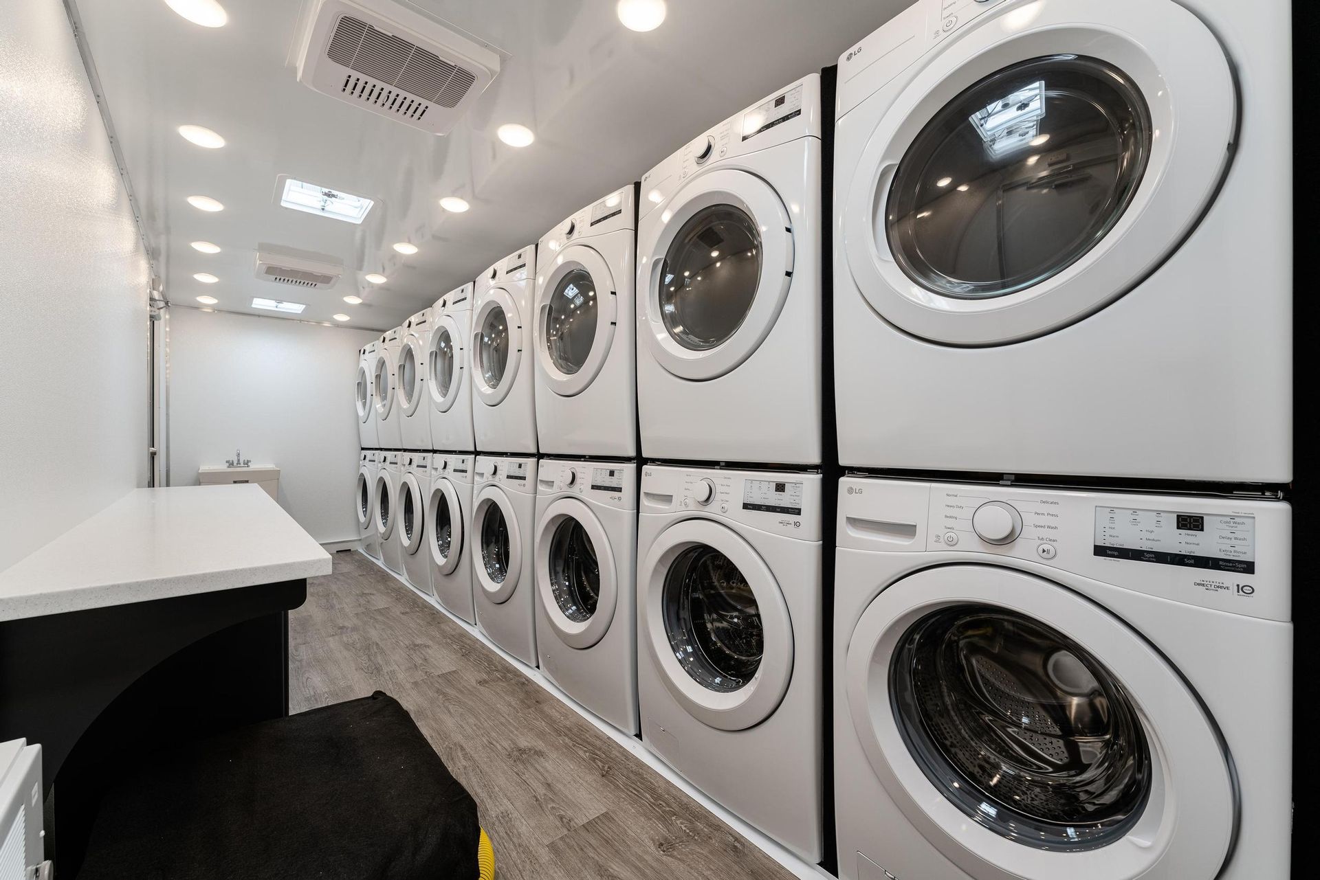 A laundromat with a lot of washers and dryers stacked on top of each other