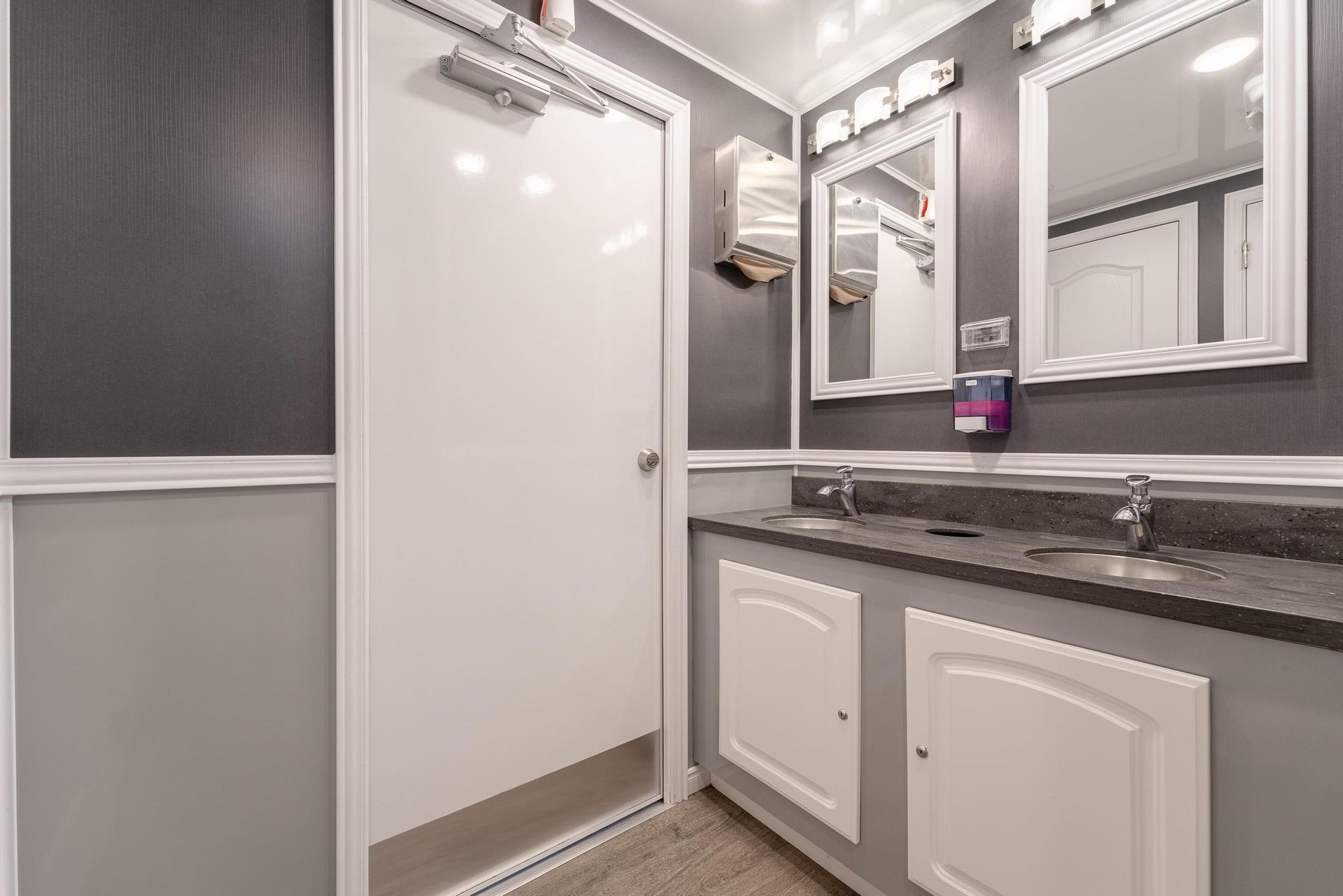 A bathroom with two sinks and two mirrors