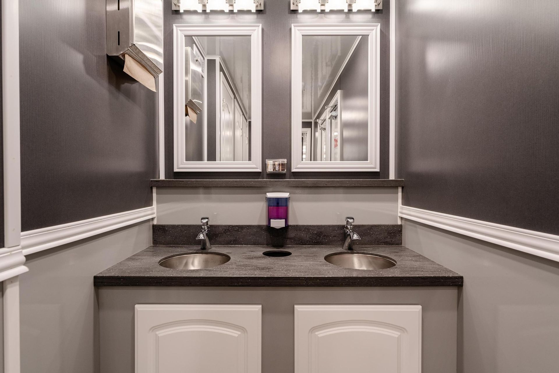 A bathroom with two sinks and two mirrors