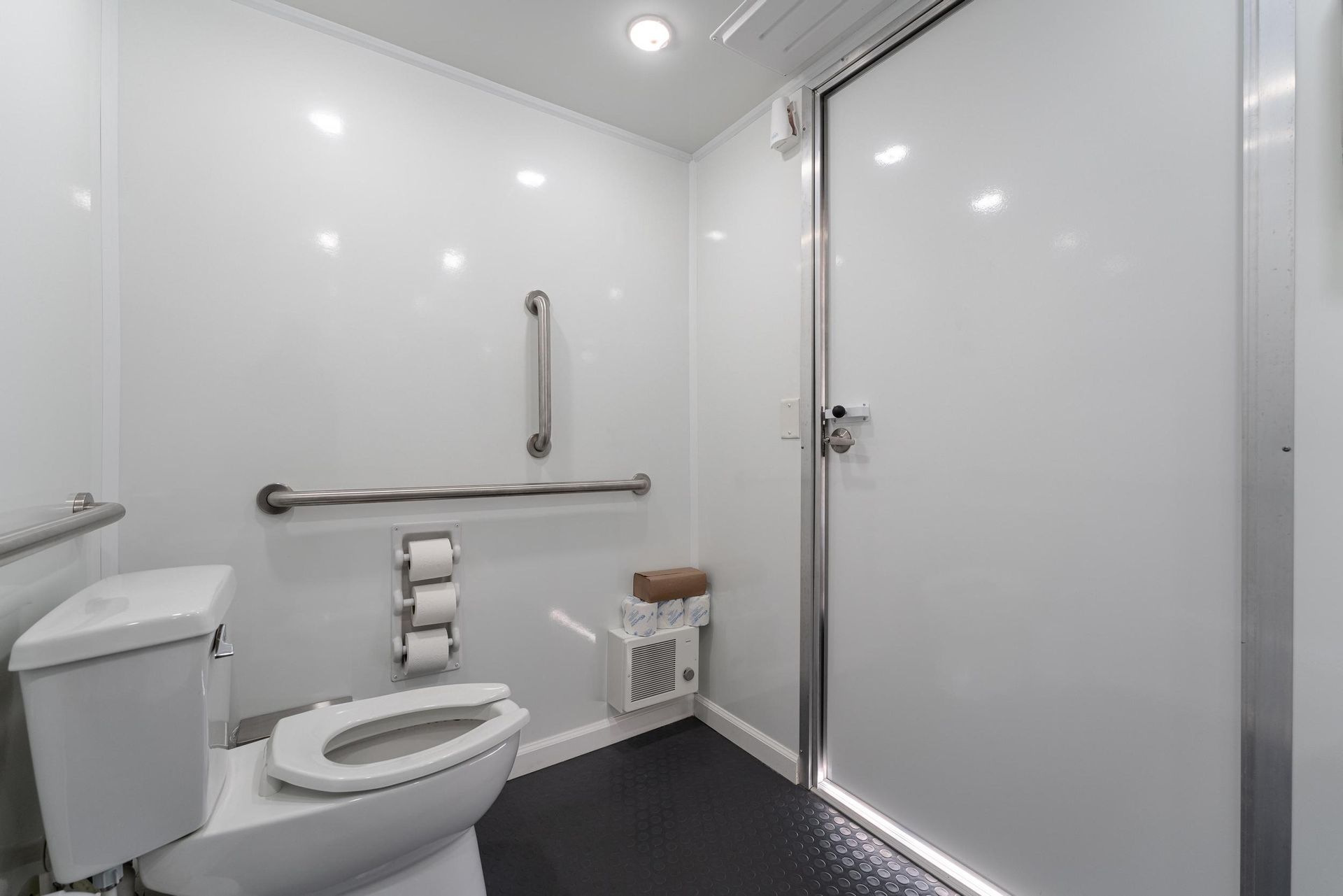 A bathroom with a toilet, sink, and door