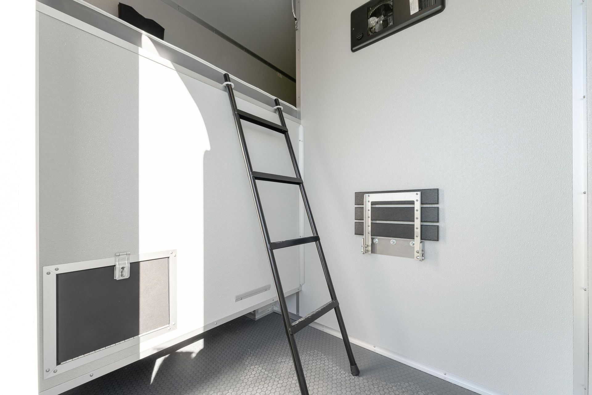 A ladder is hanging from the ceiling of a room