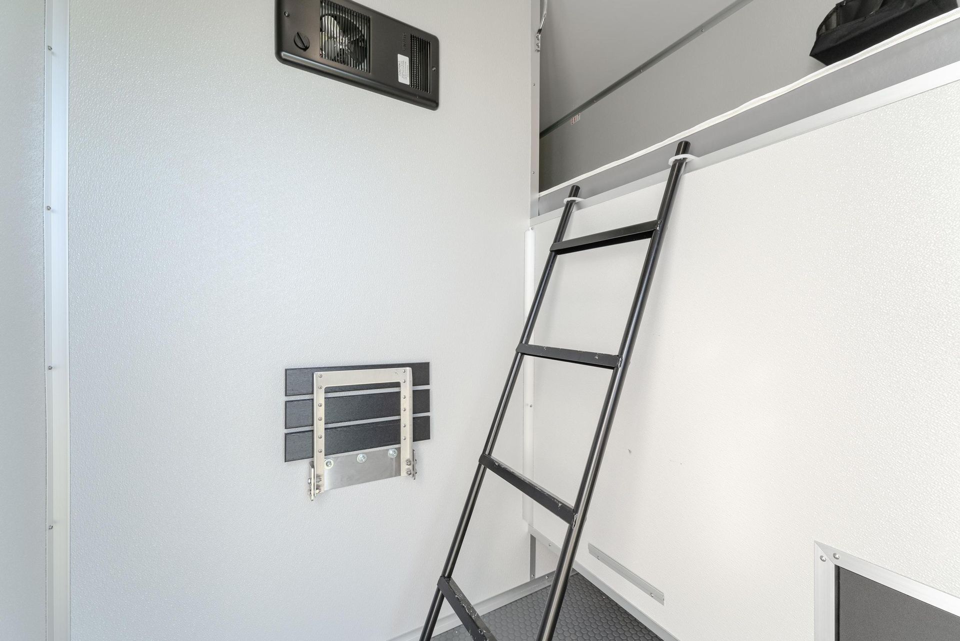 A ladder is hanging from the ceiling of a room