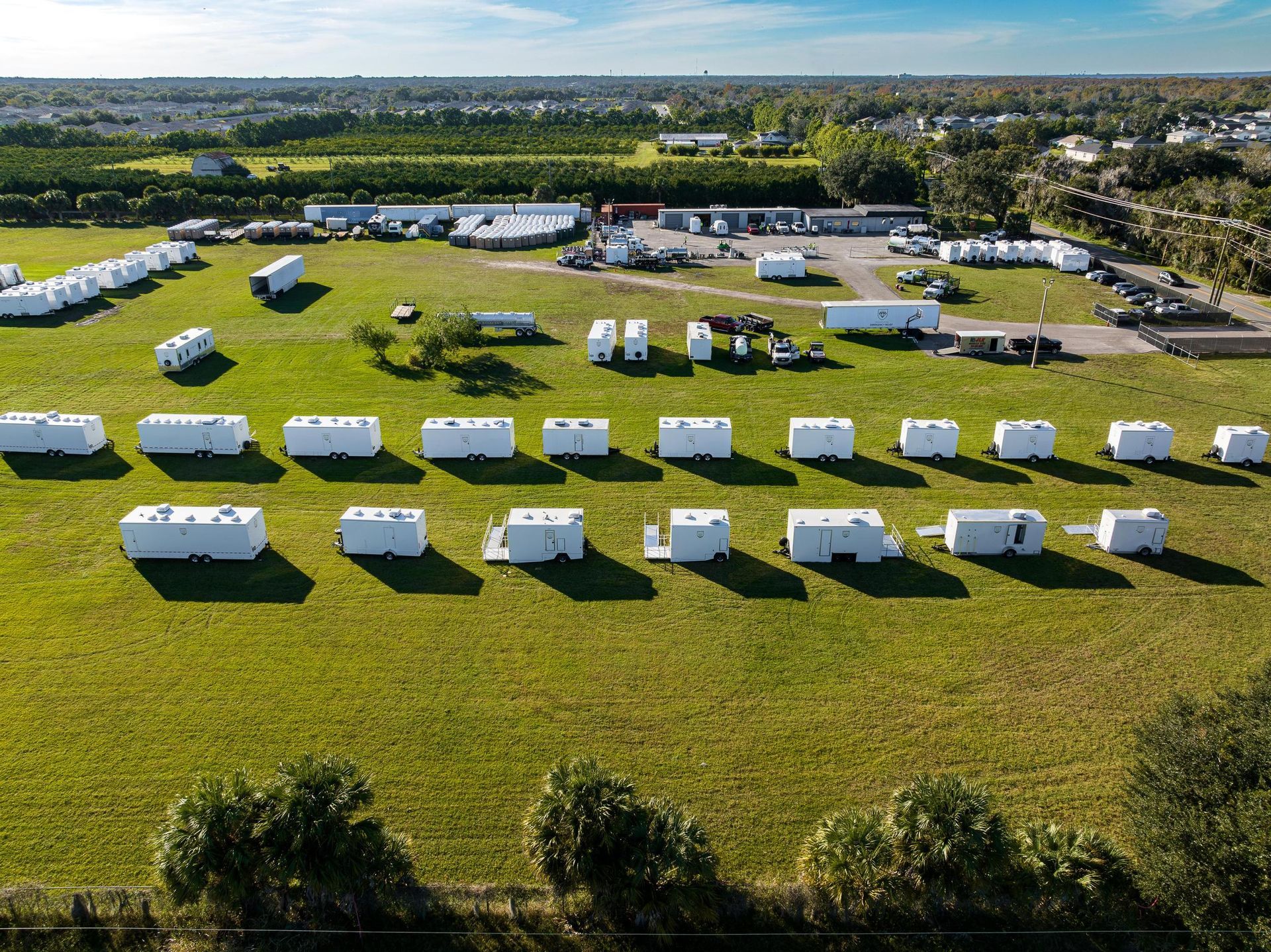 An aerial view of a field filled with lots of trailers