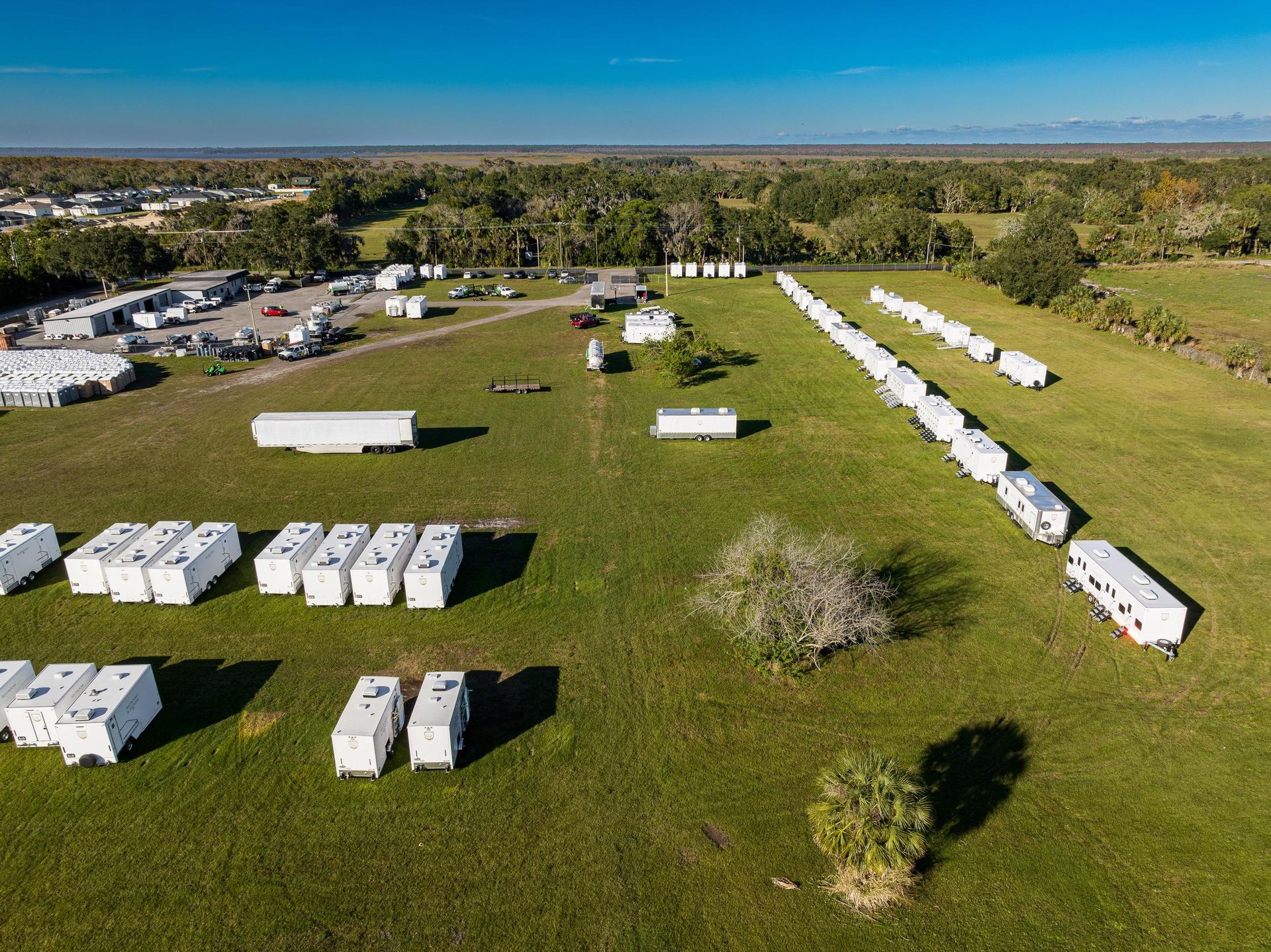 An aerial view of a field with a lot of trailers in it