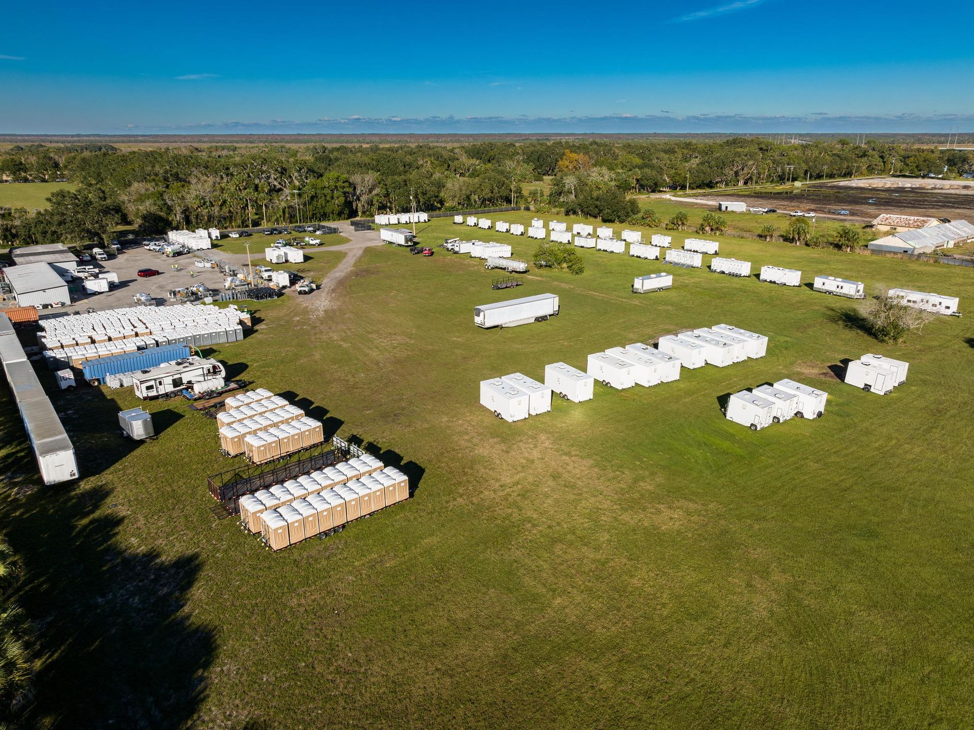 An aerial view of a large field filled with lots of trailers