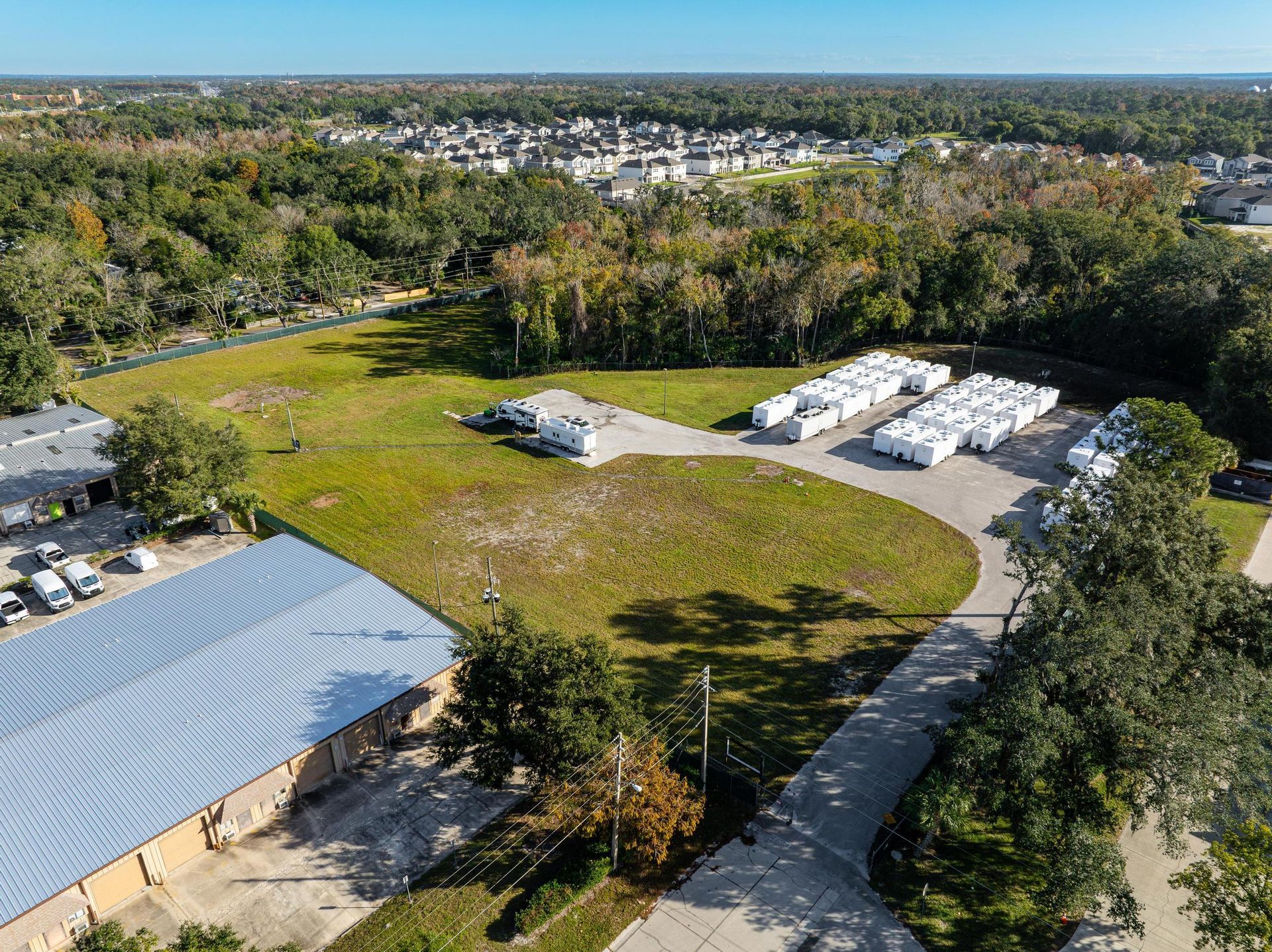 An aerial view of a large field with a lot of trailers parked in it