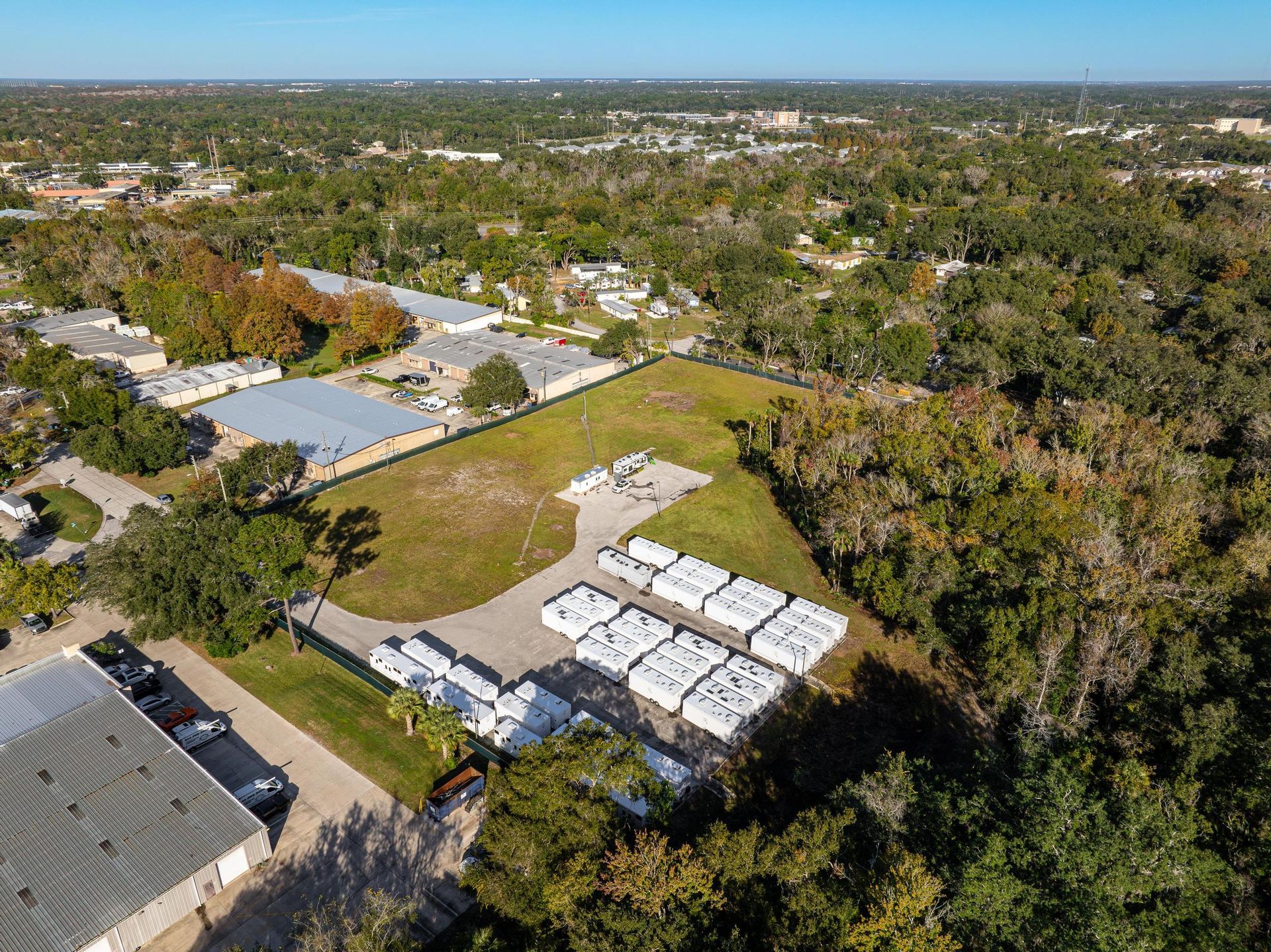 An aerial view of a residential area with lots of trees and buildings