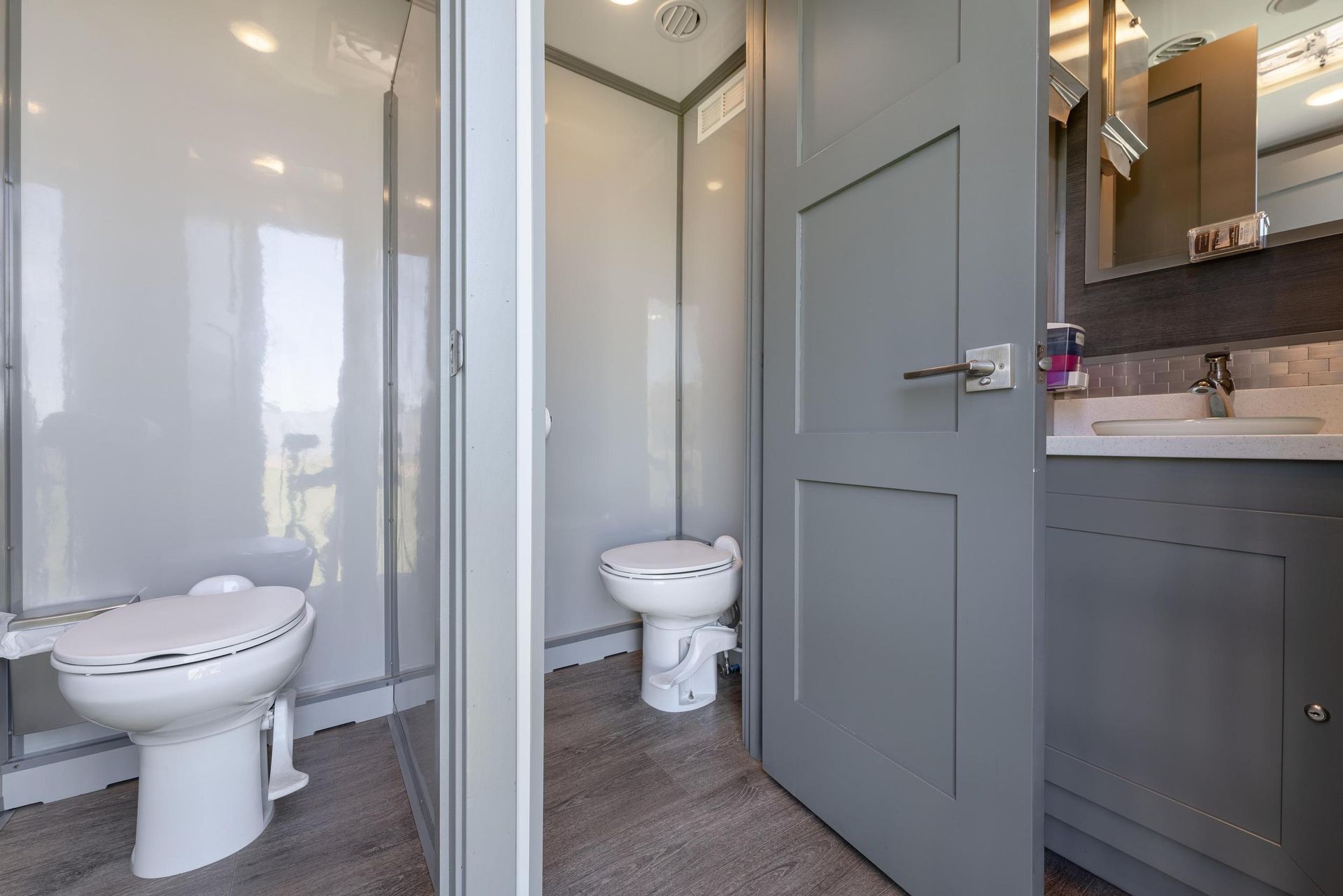 A bathroom with a toilet, sink, and mirror