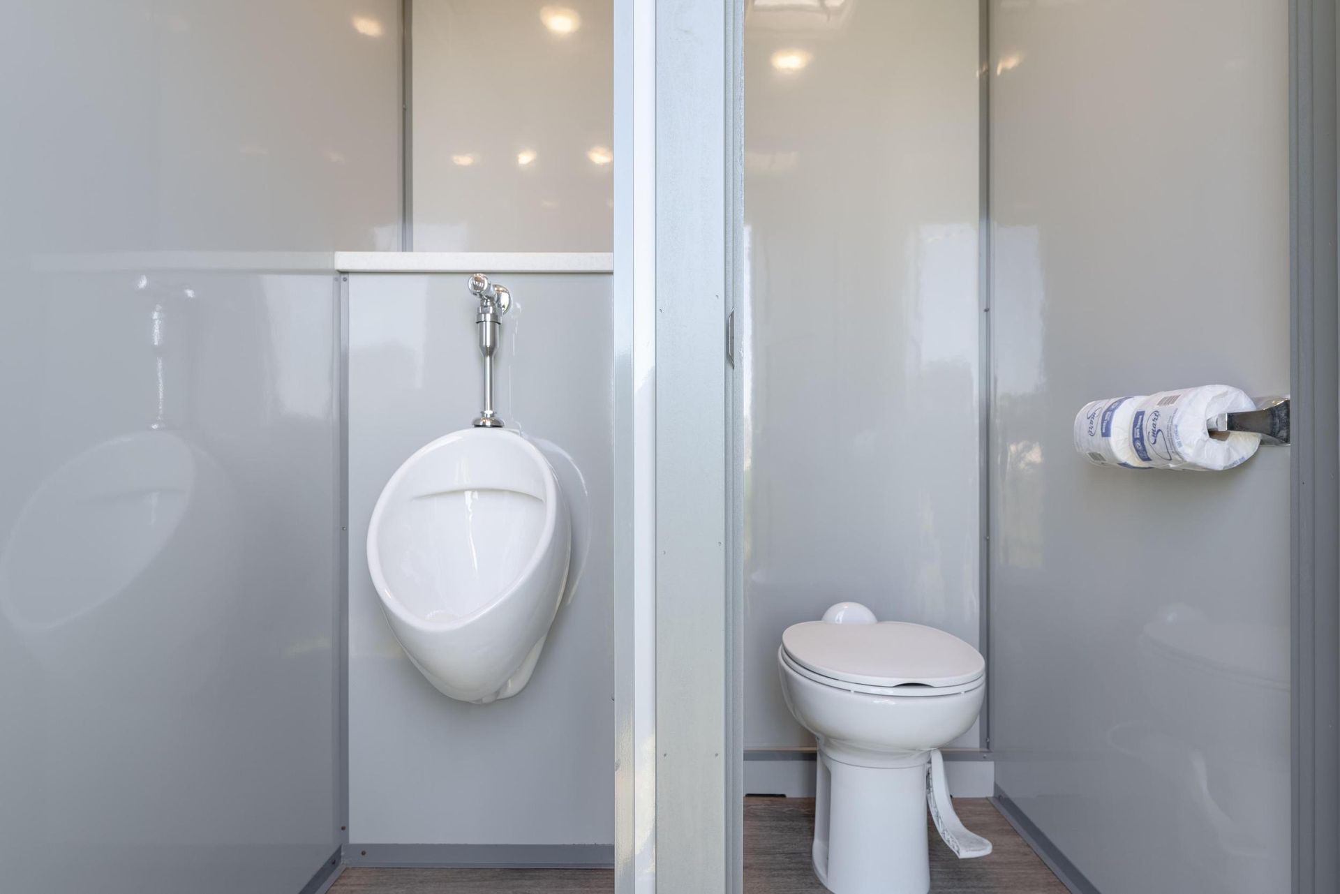 There is a urinal and a toilet in the bathroom