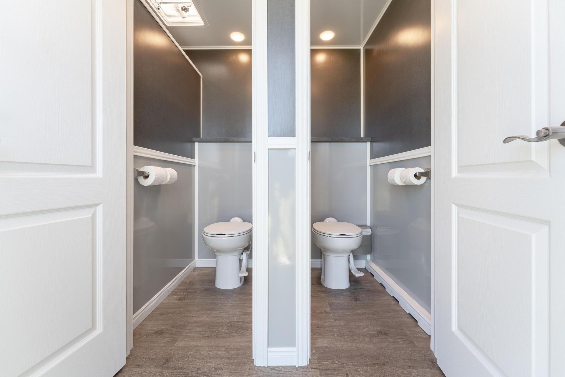 Two toilets are sitting next to each other in a bathroom