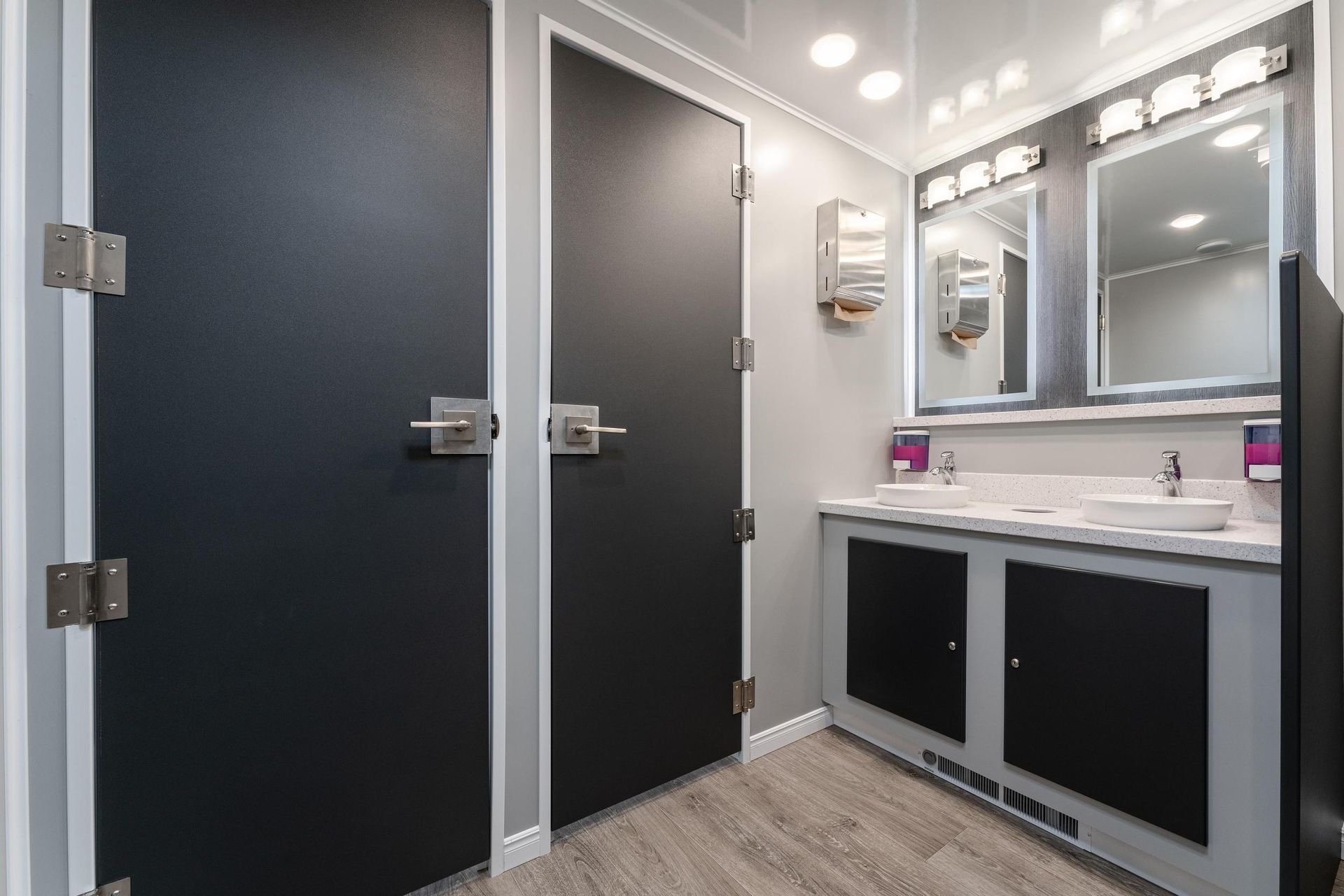 A bathroom with two sinks and two mirrors