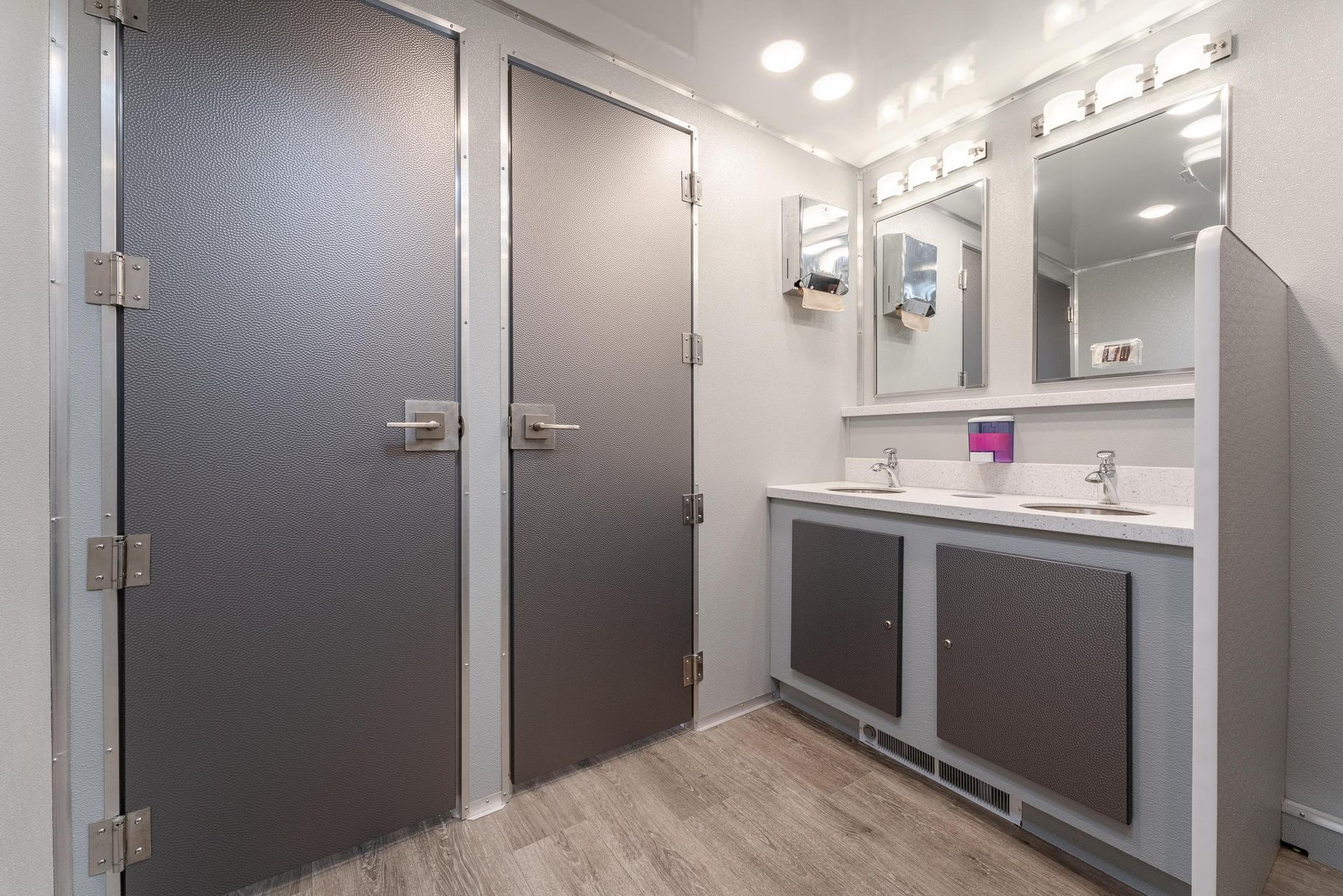 A bathroom with two sinks and two mirrors