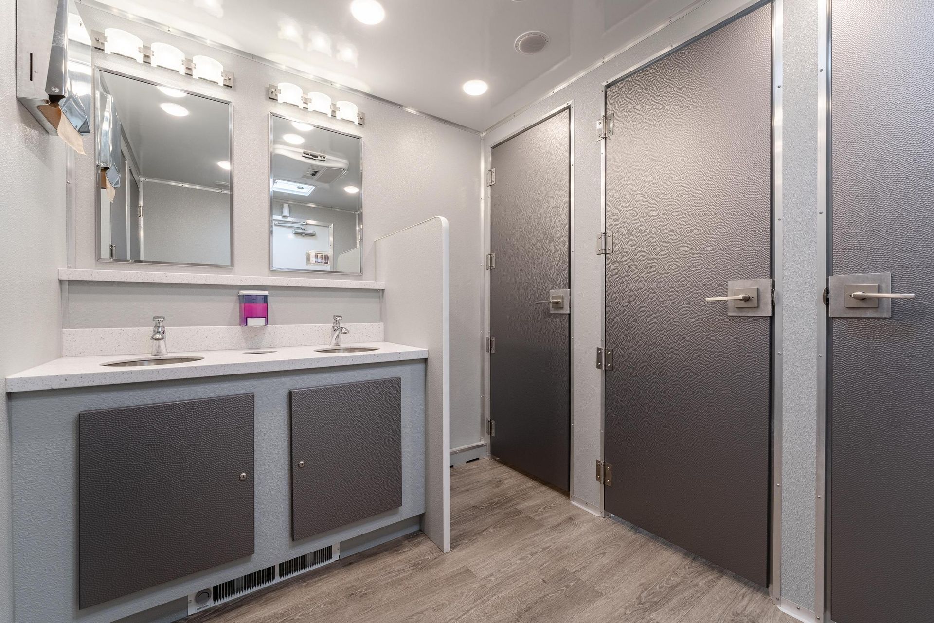 A bathroom with two sinks and two mirrors