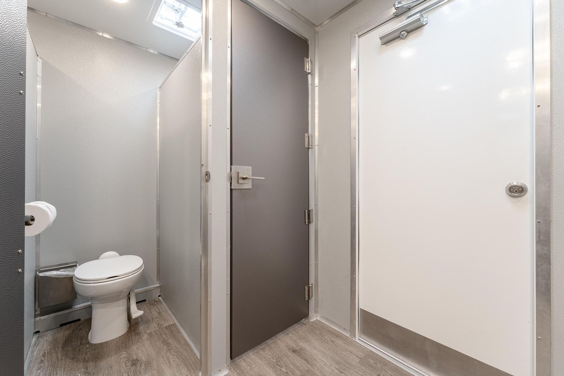 A bathroom with a toilet and a shower stall