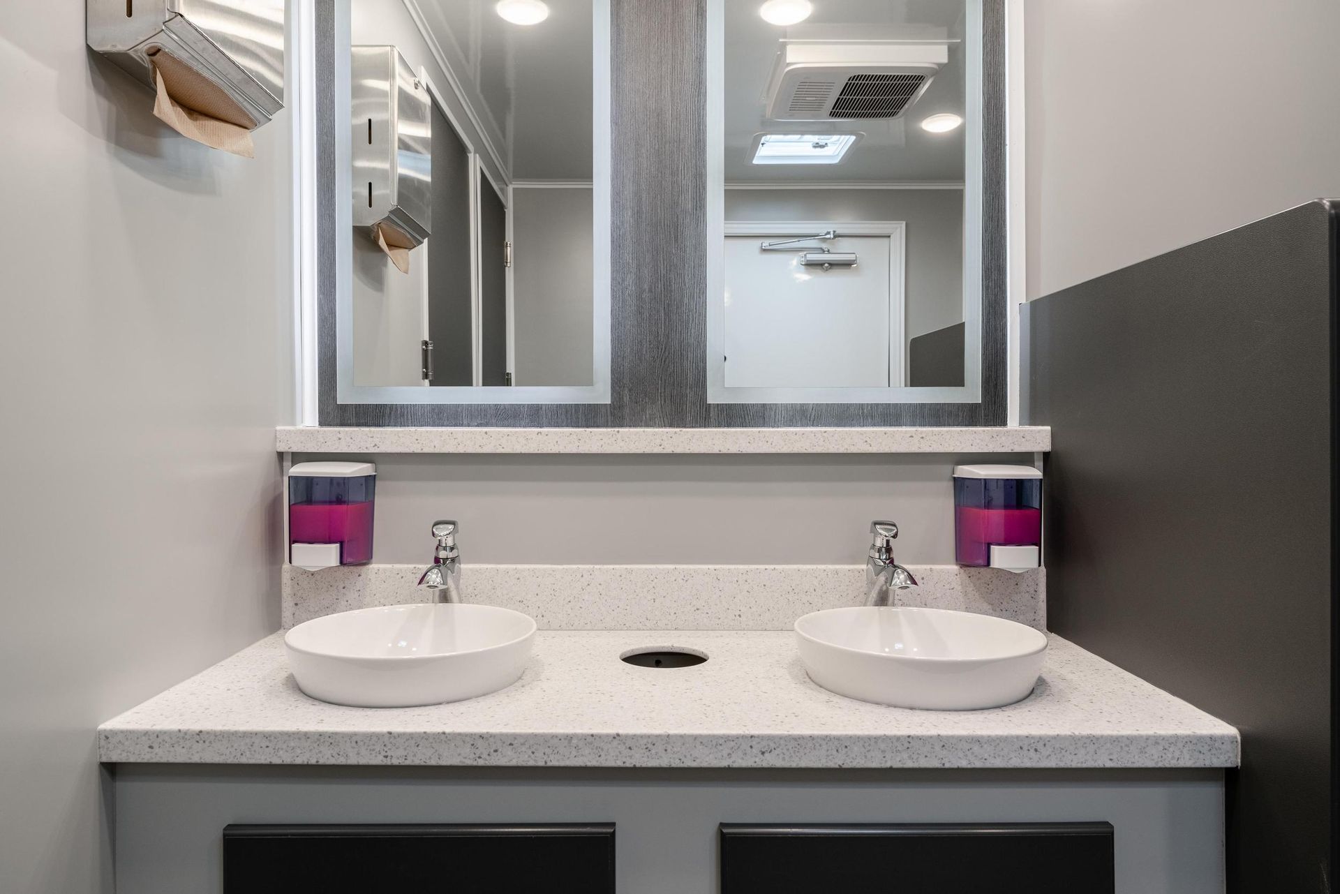 A bathroom with two sinks and a mirror