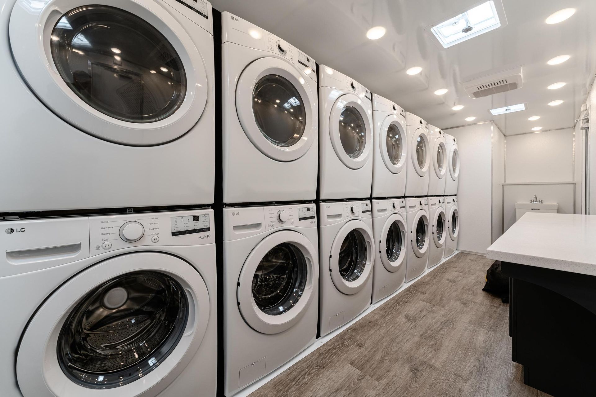 A laundromat with a lot of washers and dryers stacked on top of each other