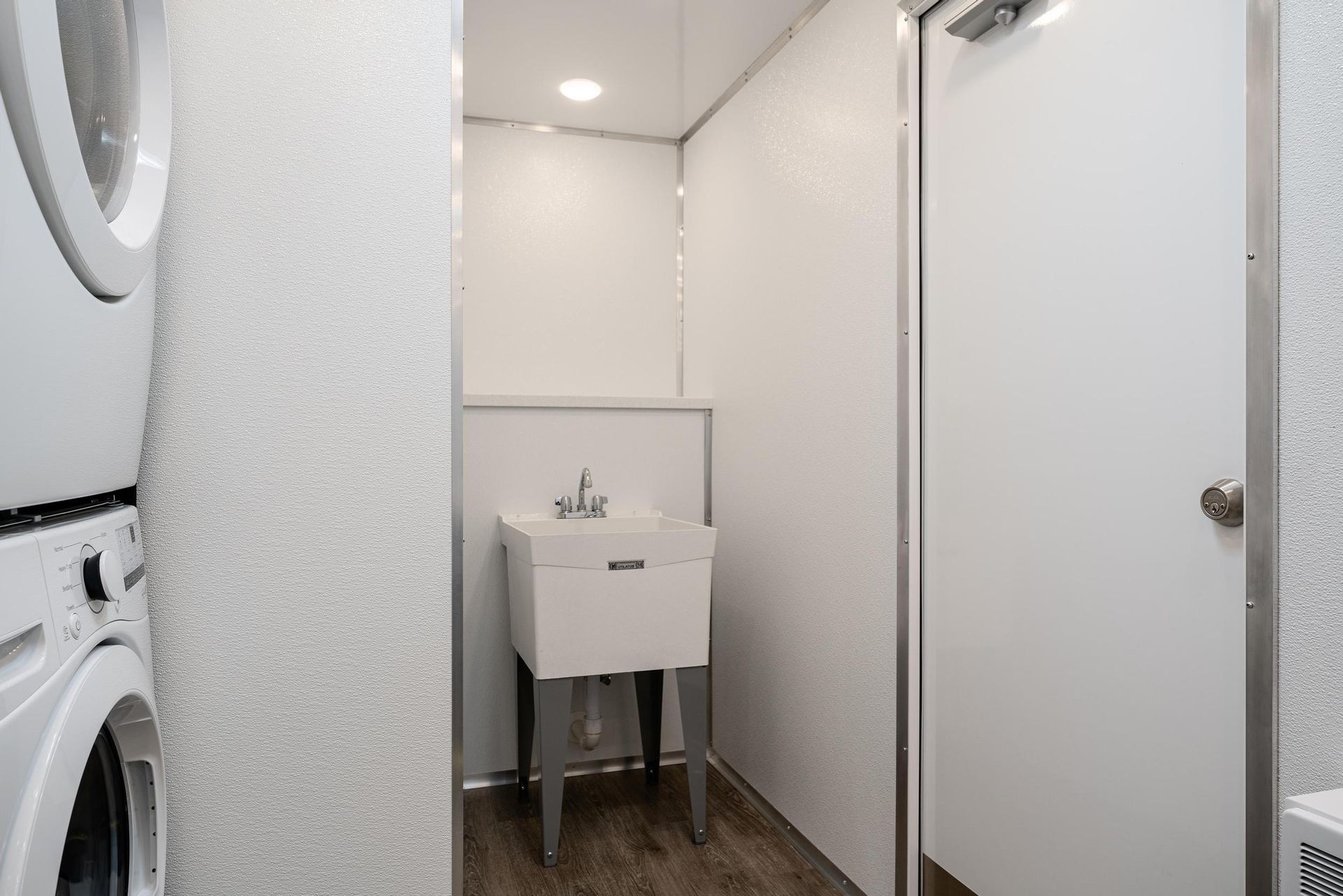 A laundry room with a washer and dryer and a sink