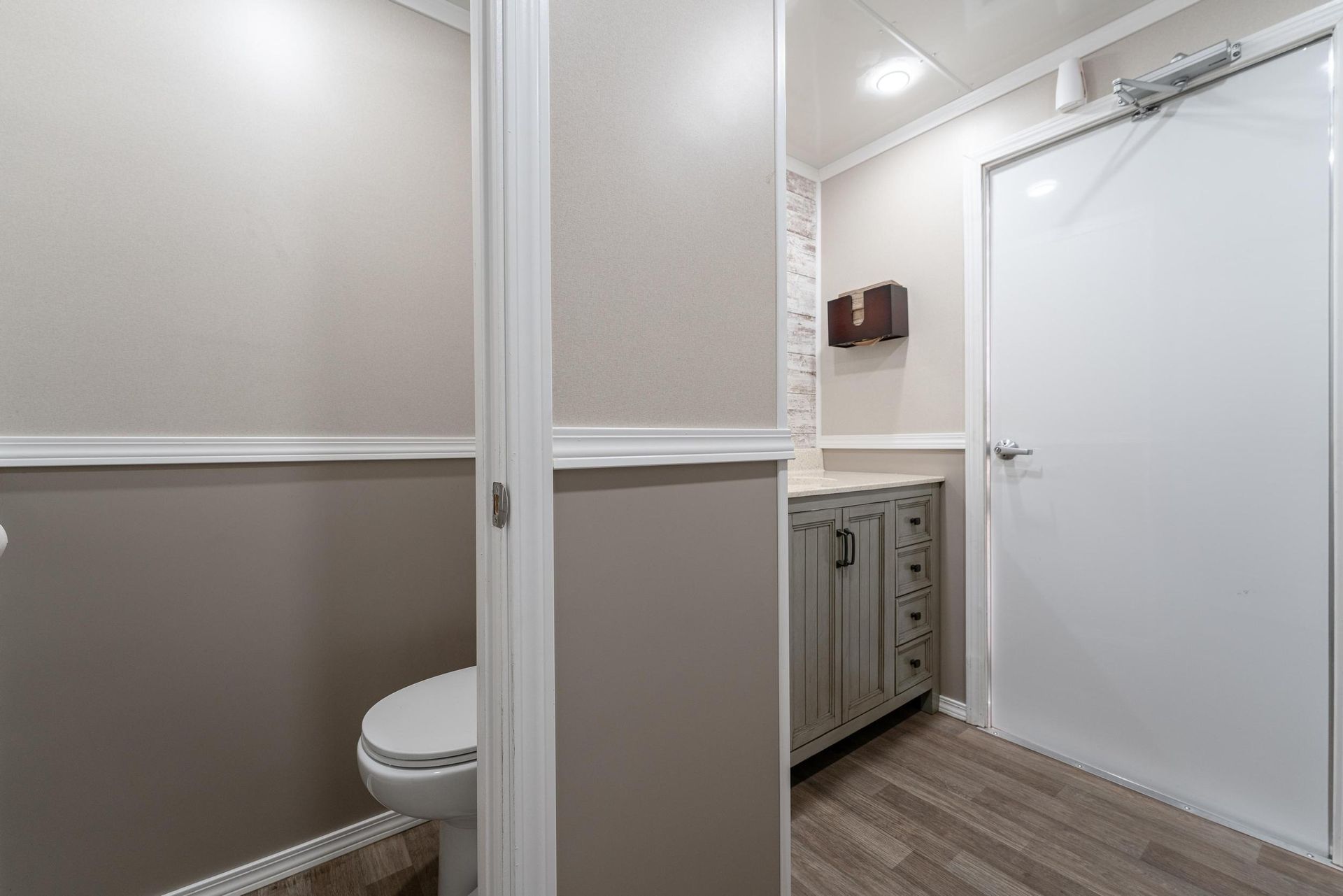 A bathroom with a toilet and a white door