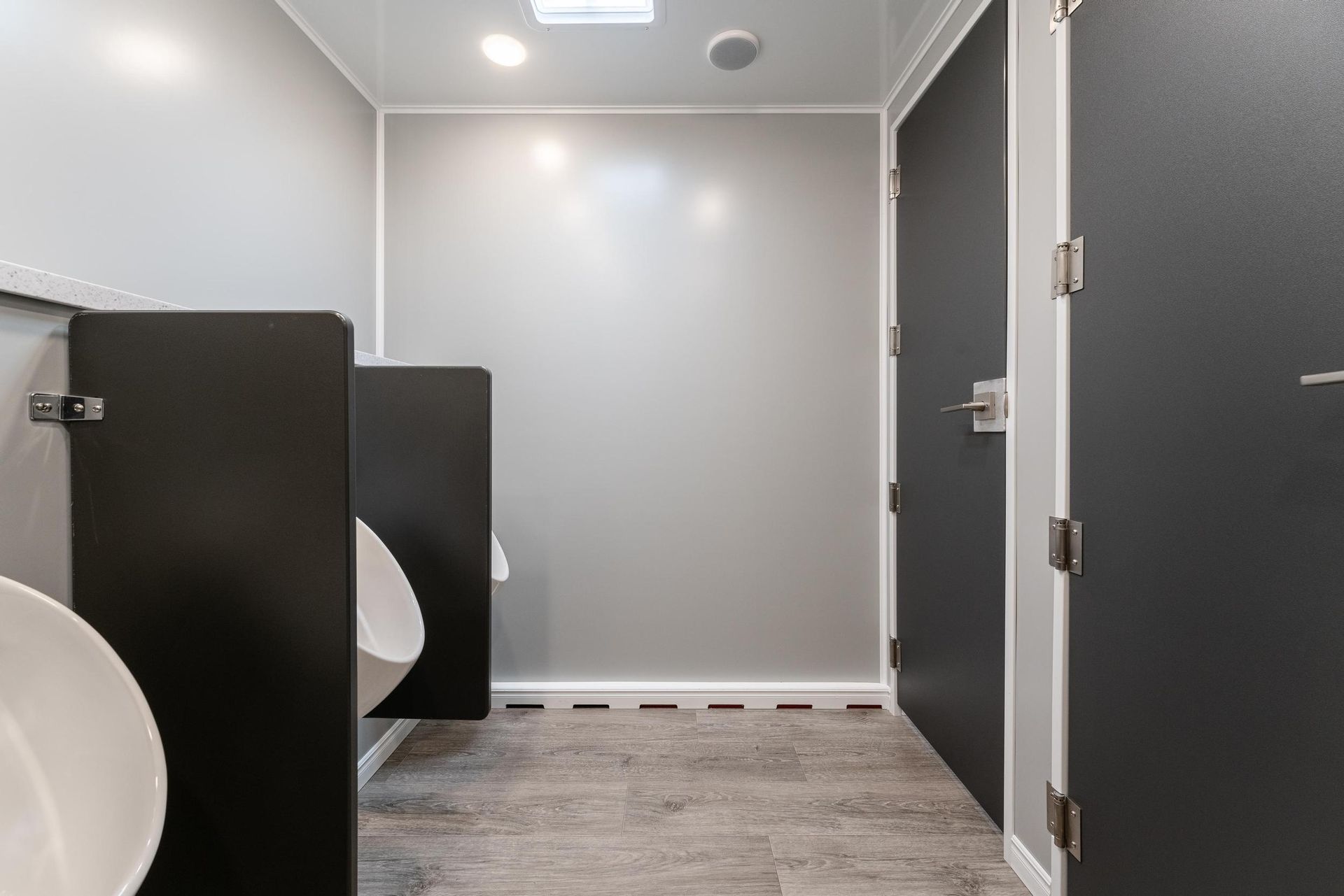 A bathroom with two urinals and a sink