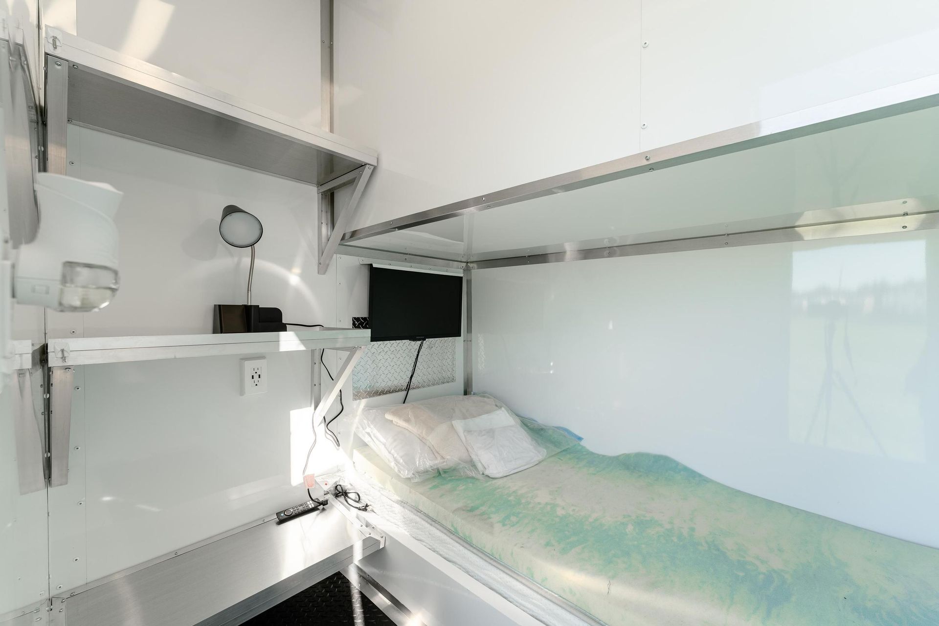 A bedroom with a bunk bed and a desk