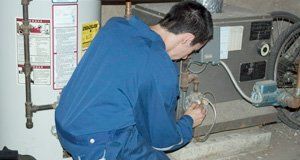 Repairman fixing a boiler