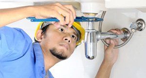 Plumber working on a sink