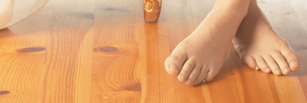 Feet standing on wood floor
