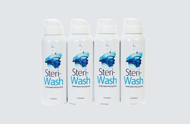 Steri-Wash bottles with white caps and blue labels on a light background.