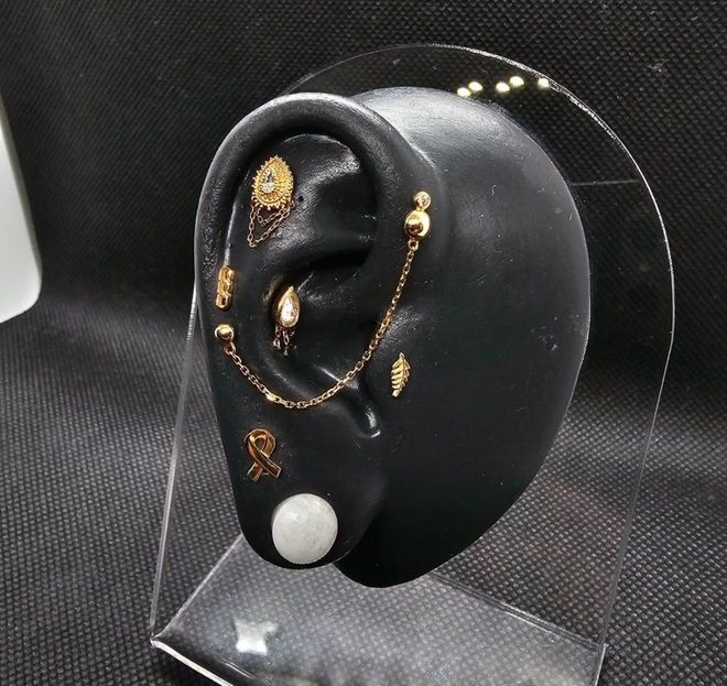 Black abstract ear sculpture with gold.