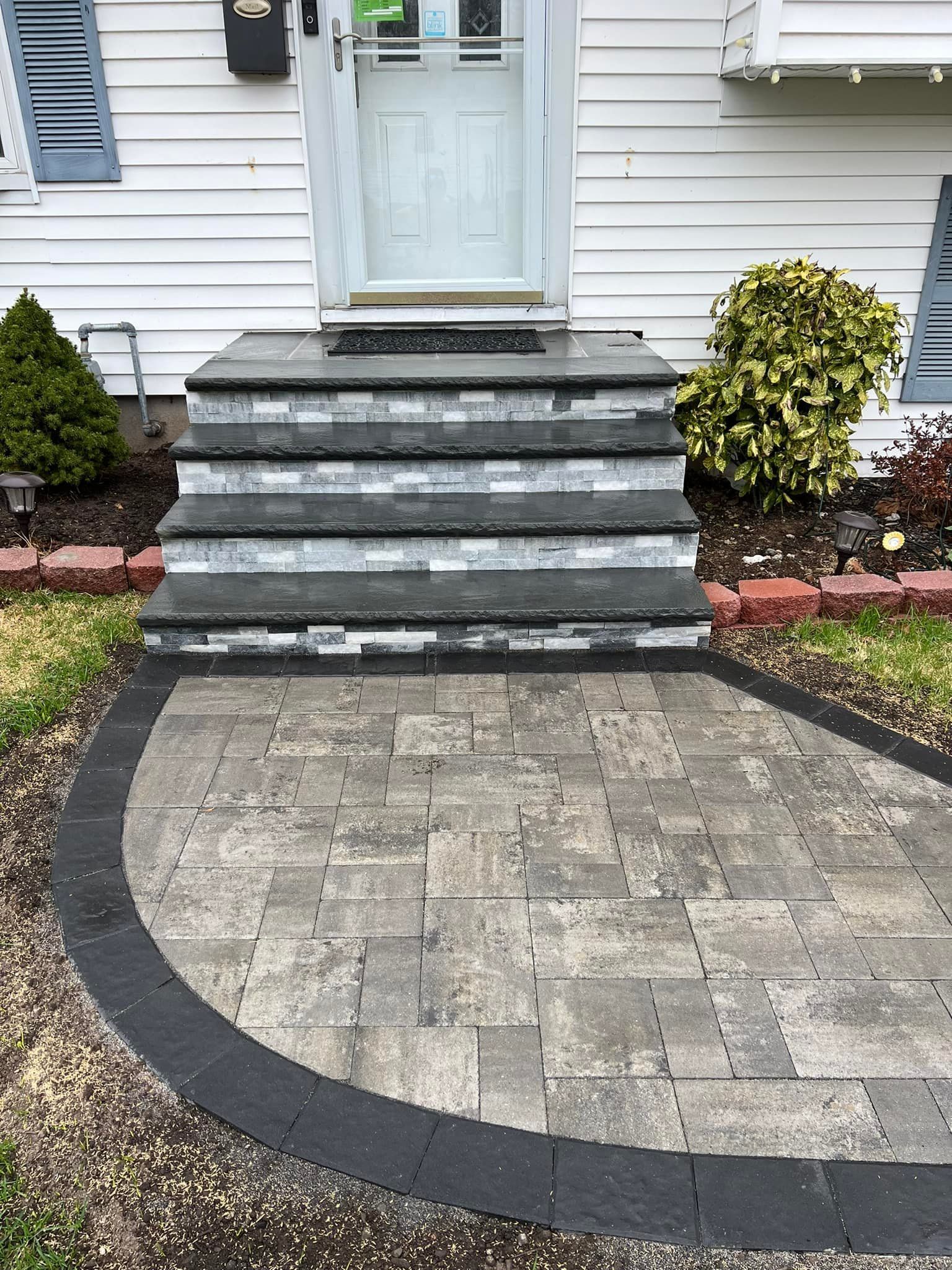 Stone steps and walkway leading to a white front door.