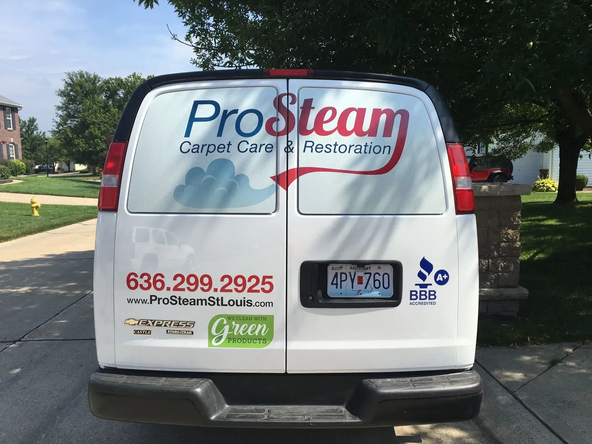 A white van with the word prosteam on the back