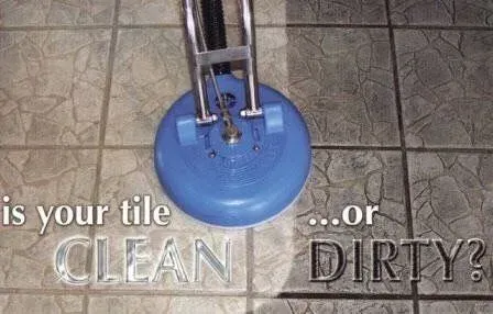 A blue vacuum cleaner is cleaning a tile floor.