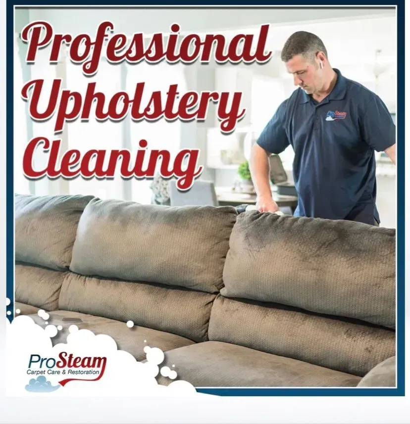 A man is standing next to a couch that says professional upholstery cleaning