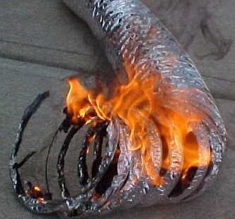 A close up of a metal pipe with flames coming out of it.